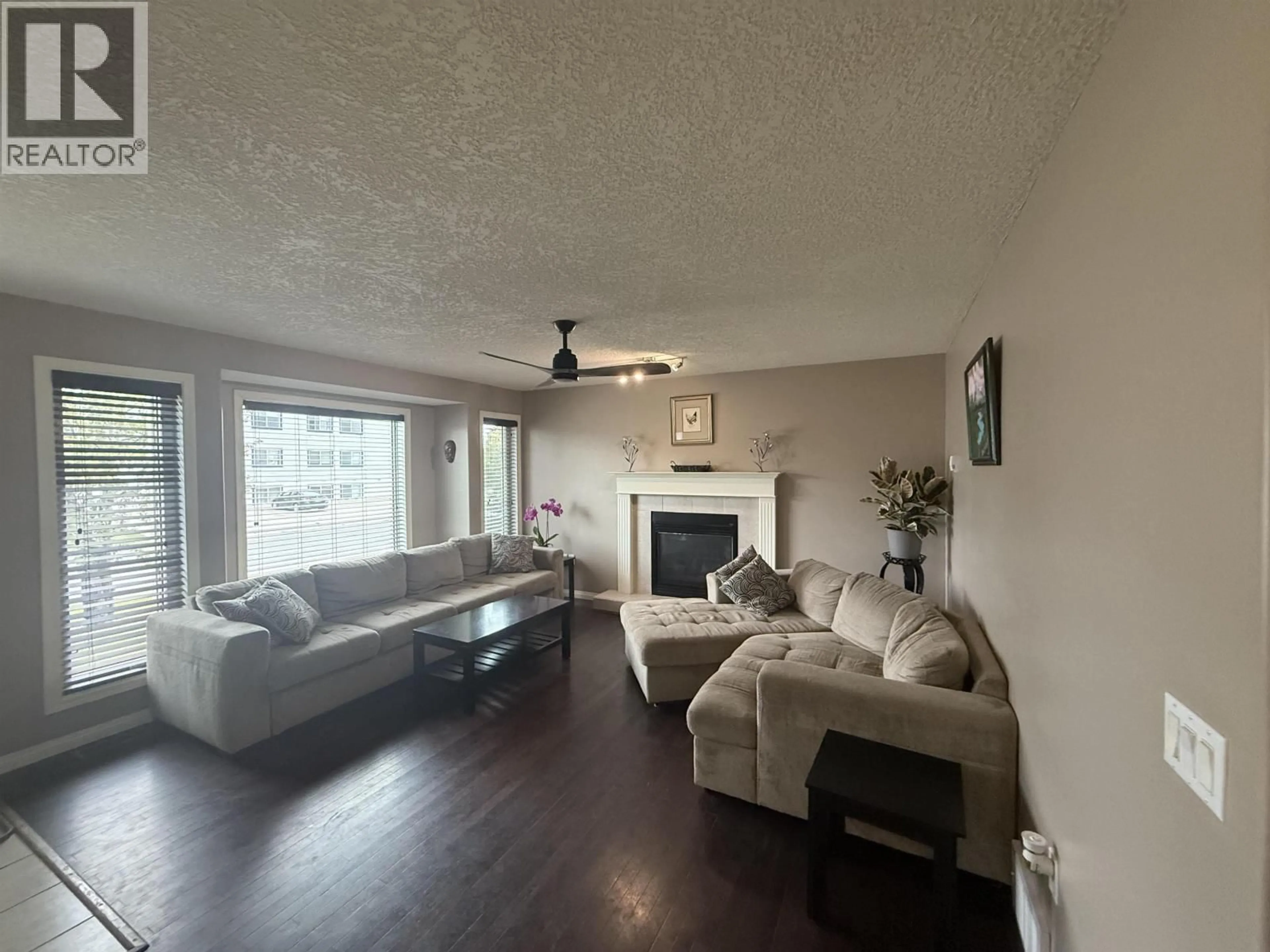 Living room with furniture, wood/laminate floor for 9611 102 AVENUE, Fort St. John British Columbia V1J2C7
