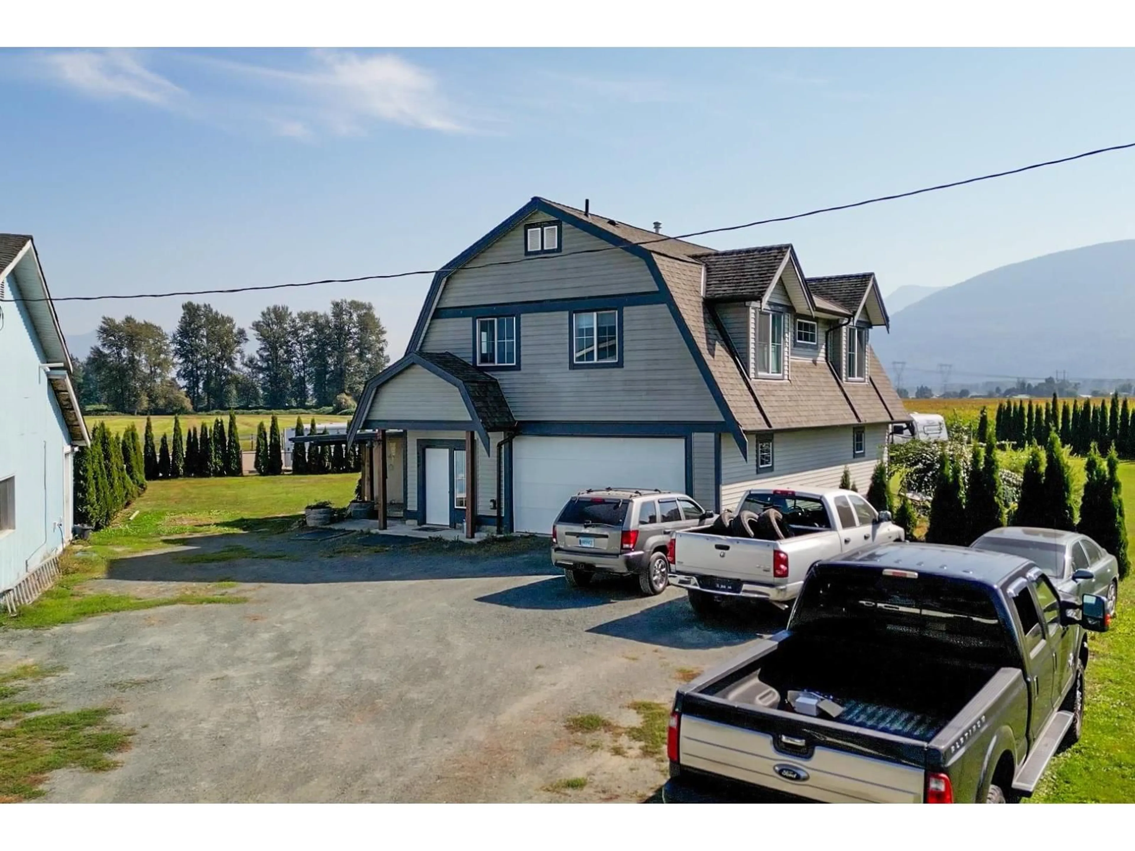 A pic from outside/outdoor area/front of a property/back of a property/a pic from drone, mountain view for 6050 CHADSEY ROAD, Chilliwack British Columbia V2R4P2