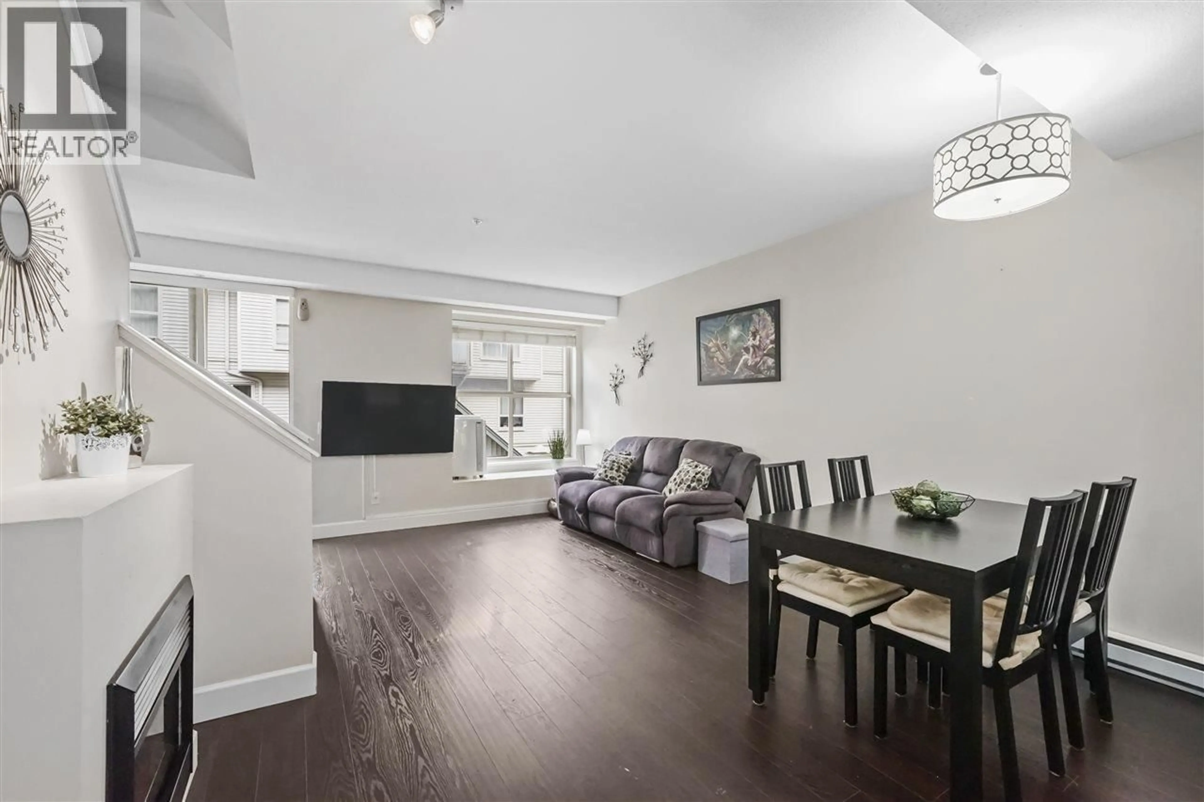Living room with furniture, wood/laminate floor for 228 - 2108 ROWLAND STREET, Port Coquitlam British Columbia V3C0C1