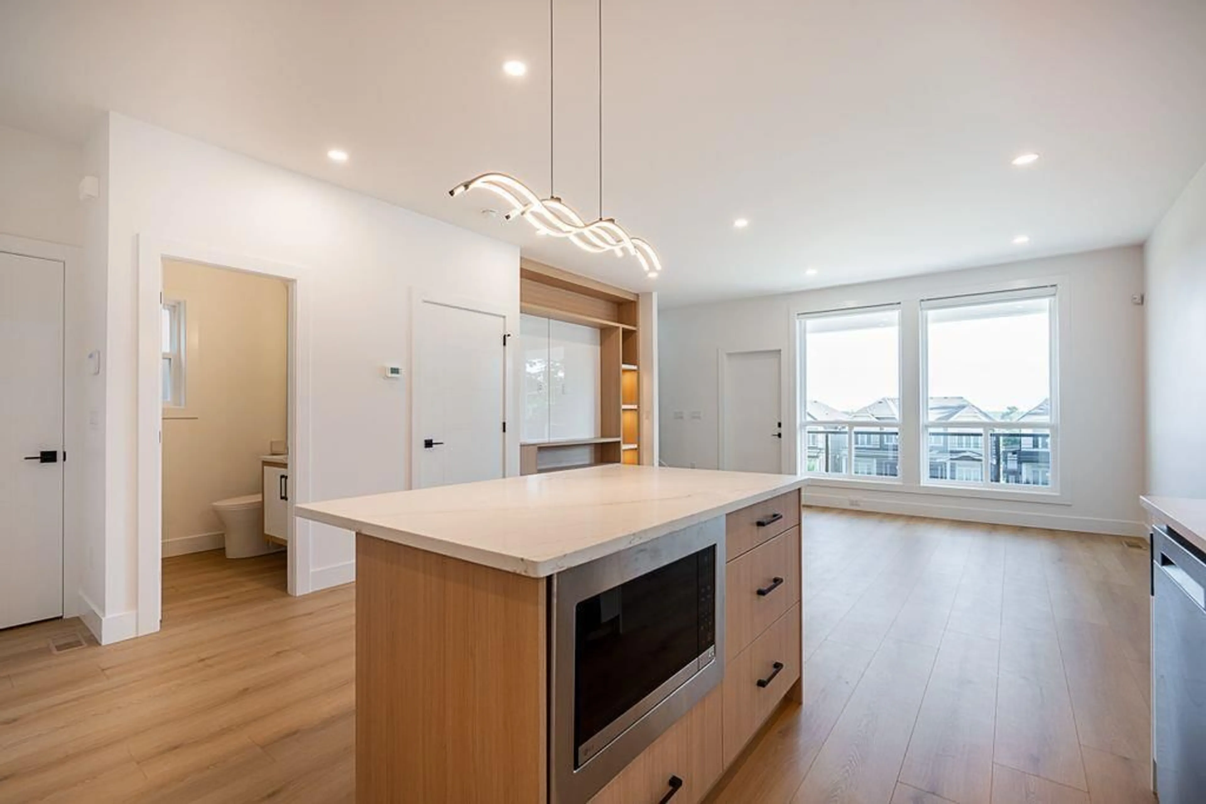 Open concept kitchen, wood/laminate floor for 101 - 16693 16, Surrey British Columbia V3Z0T3