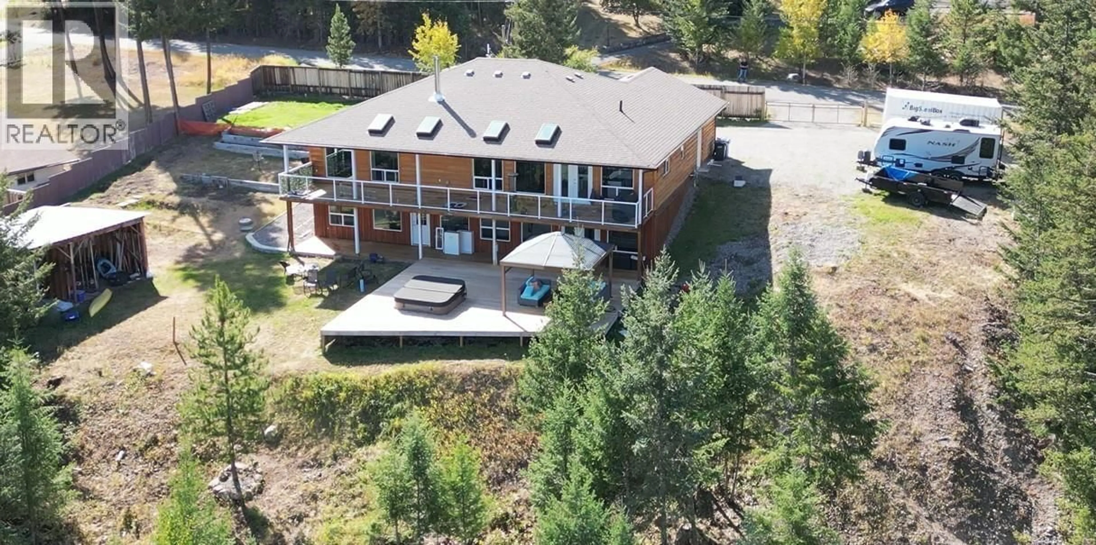 A pic from outside/outdoor area/front of a property/back of a property/a pic from drone, water/lake/river/ocean view for 4849 BRYAN CRESCENT, 108 Mile Ranch British Columbia V0K2Z0