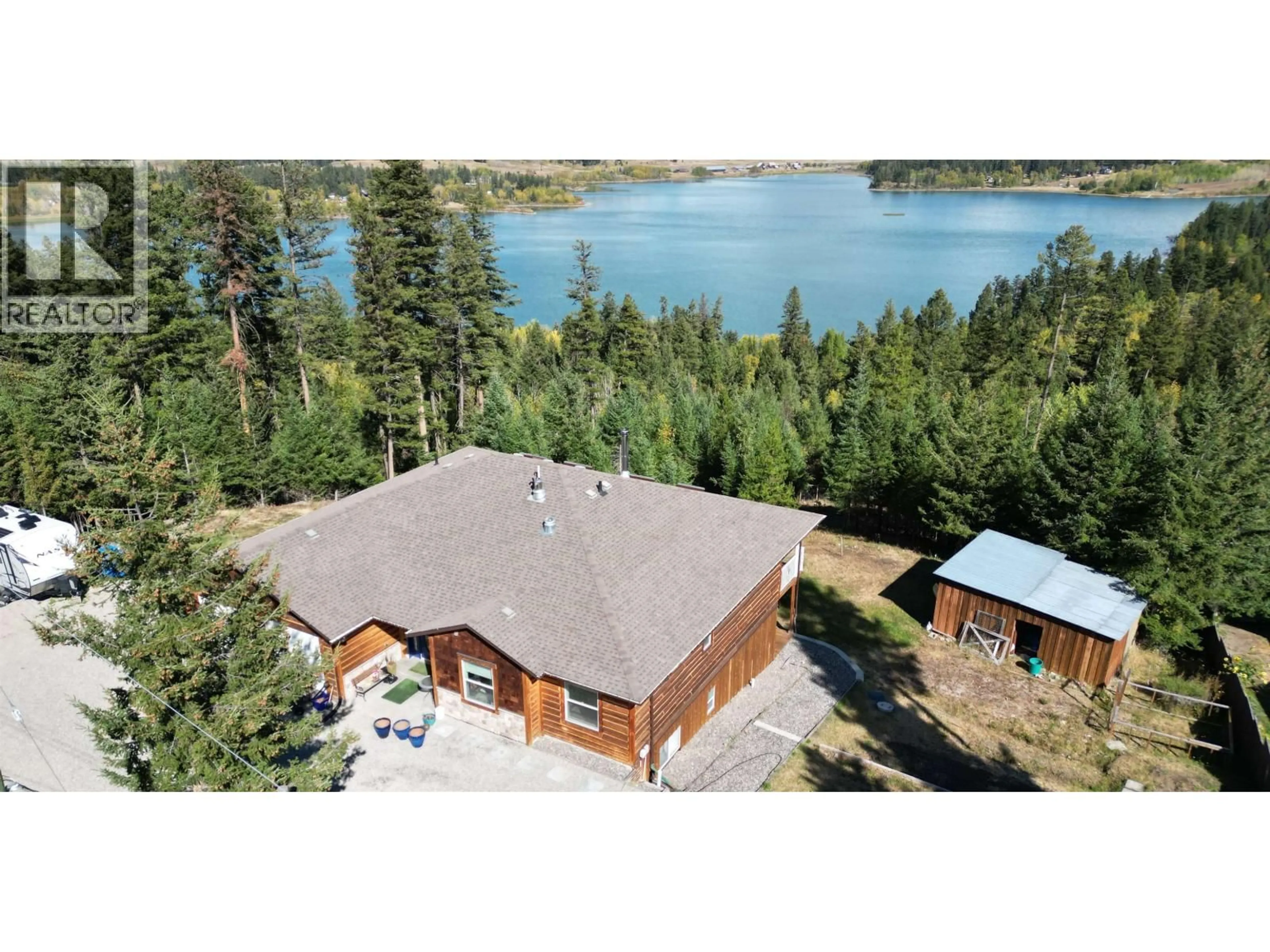 A pic from outside/outdoor area/front of a property/back of a property/a pic from drone, water/lake/river/ocean view for 4849 BRYAN CRESCENT, 108 Mile Ranch British Columbia V0K2Z0