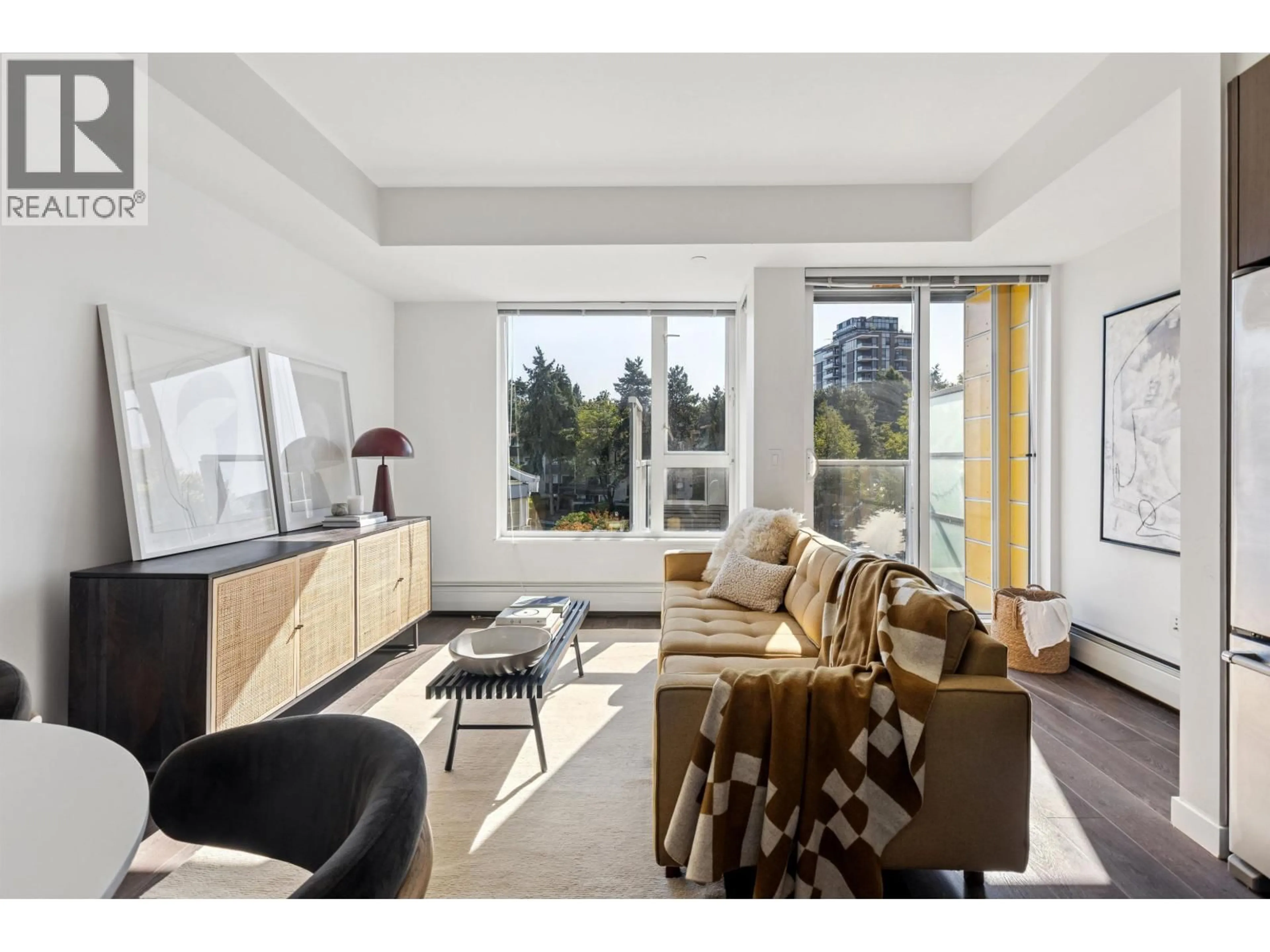 Living room with furniture, wood/laminate floor for 605 - 417 GREAT NORTHERN WAY, Vancouver British Columbia V5T0G7