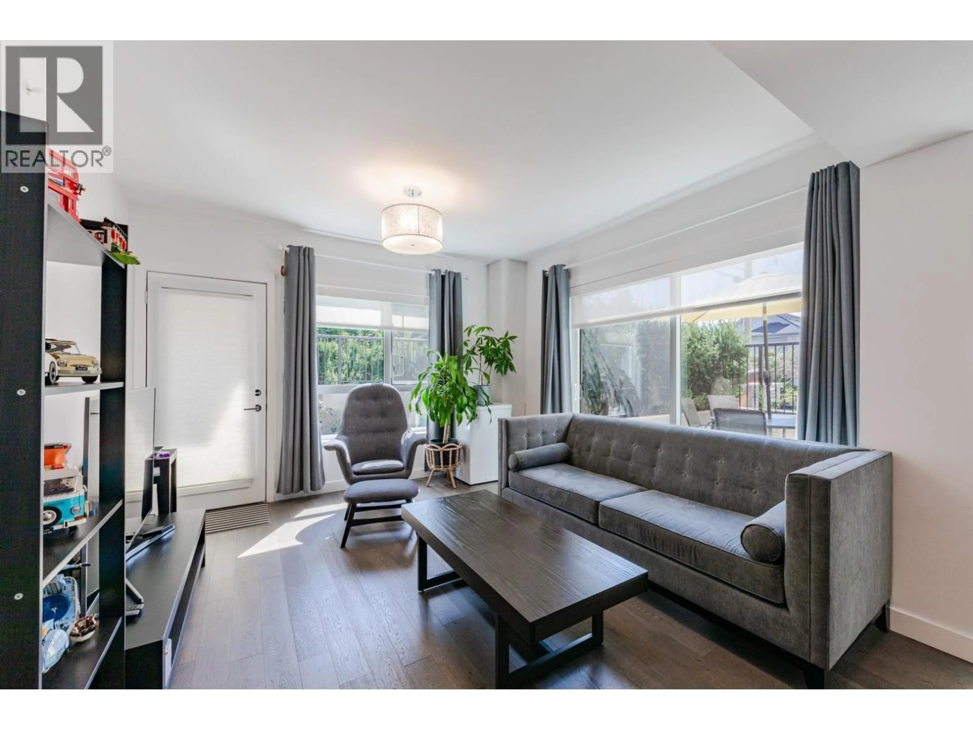 Living room with furniture, wood/laminate floor for 104 - 7828 GRANVILLE STREET, Vancouver British Columbia V6P4Z2
