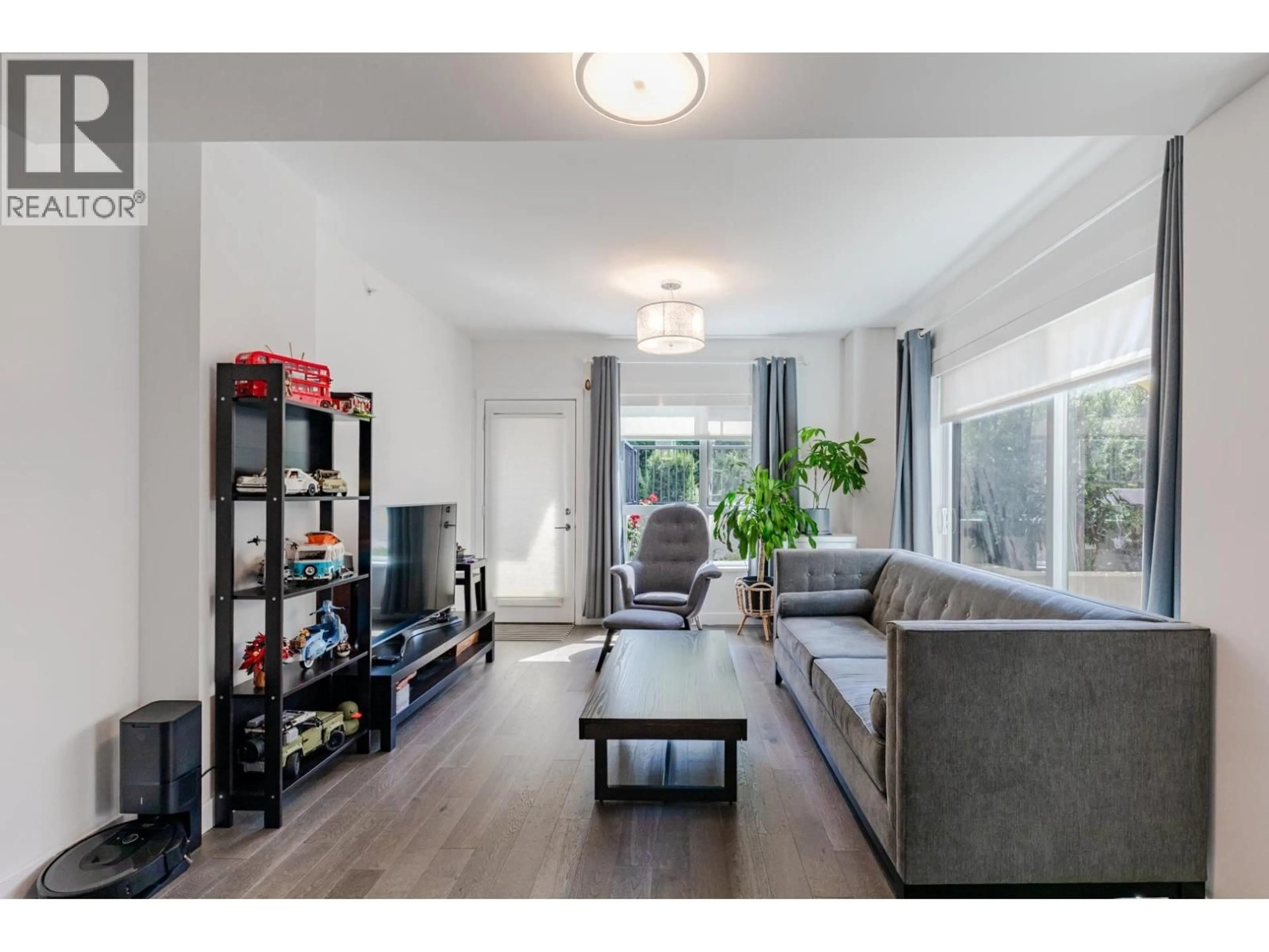 Living room with furniture, wood/laminate floor for 104 - 7828 GRANVILLE STREET, Vancouver British Columbia V6P4Z2
