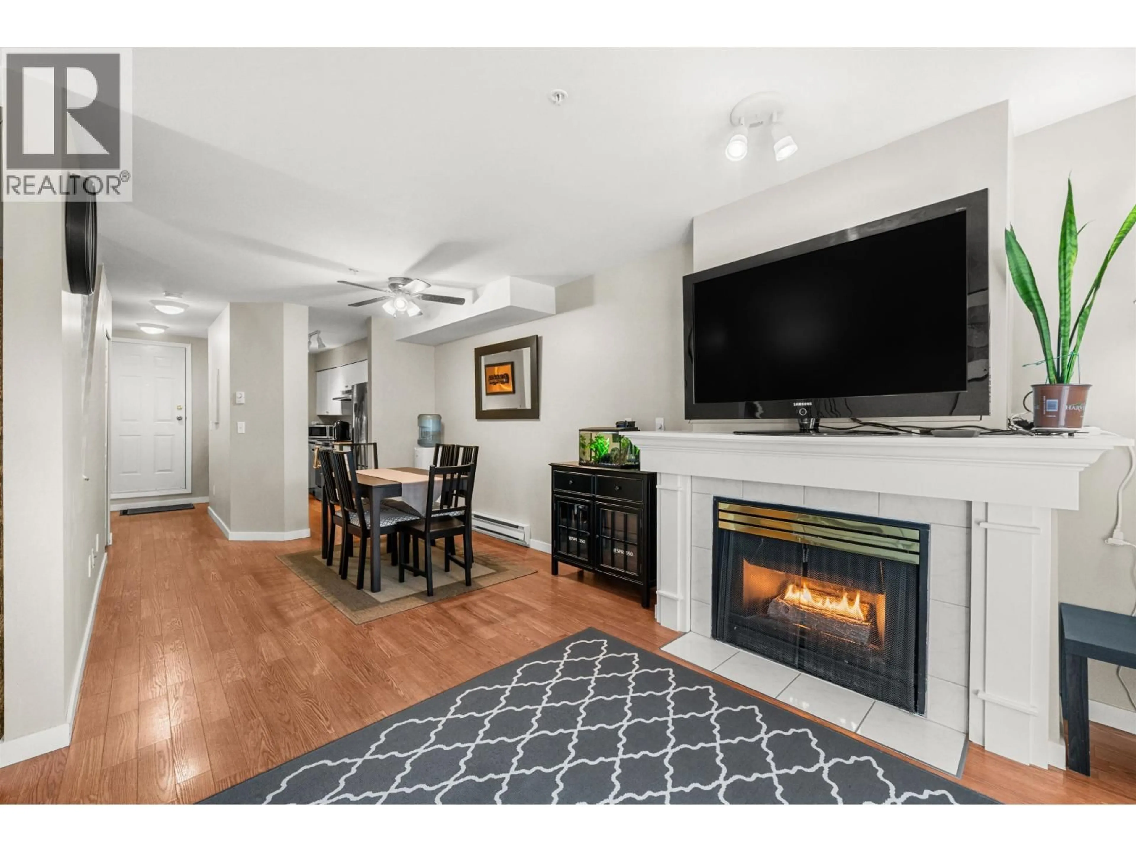 Living room with furniture, wood/laminate floor for 102 - 1570 PRAIRIE AVENUE, Port Coquitlam British Columbia V3B1T4