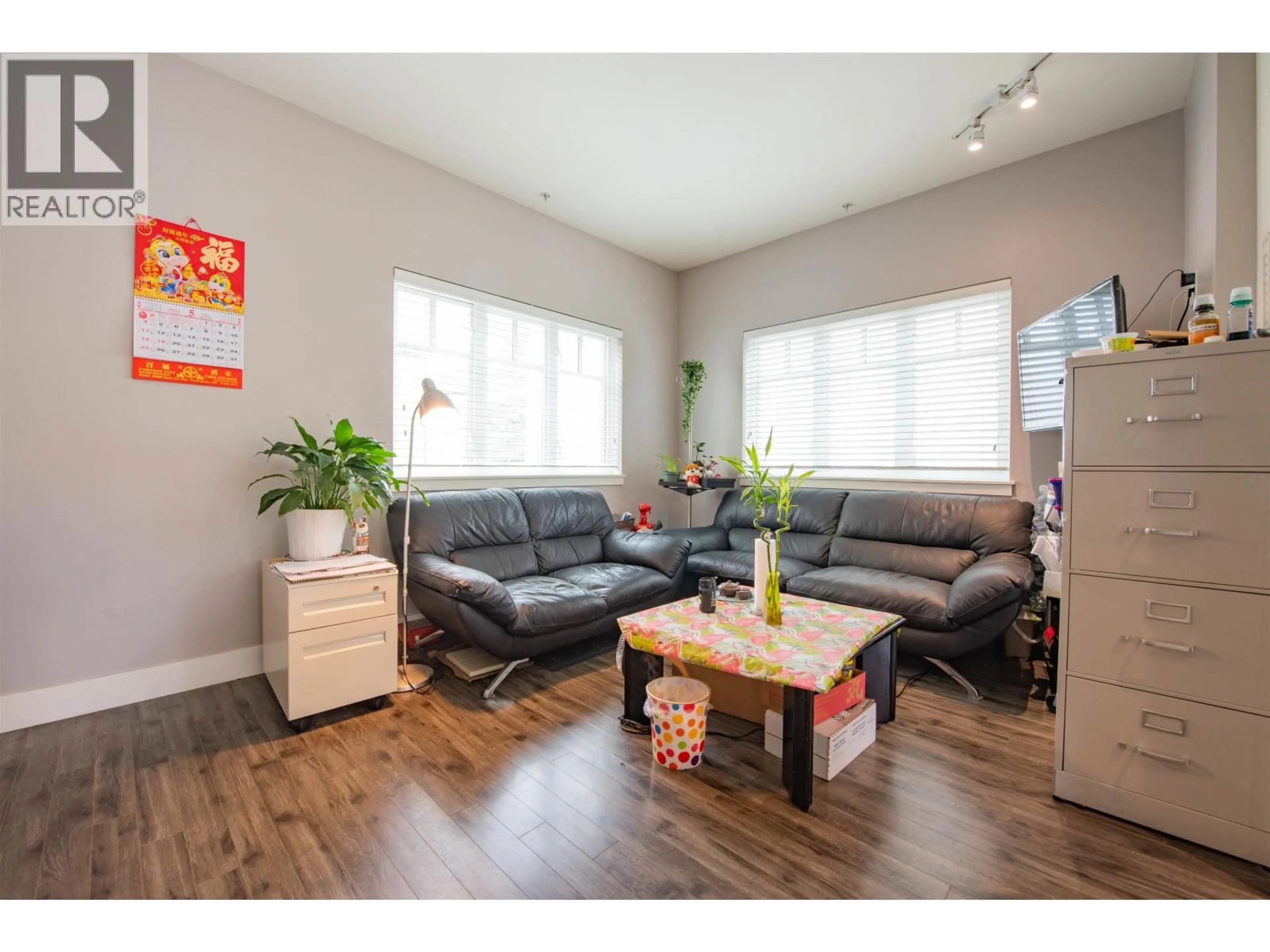 Living room with furniture, wood/laminate floor for 207 - 2263 TRIUMPH STREET, Vancouver British Columbia V5L1L2