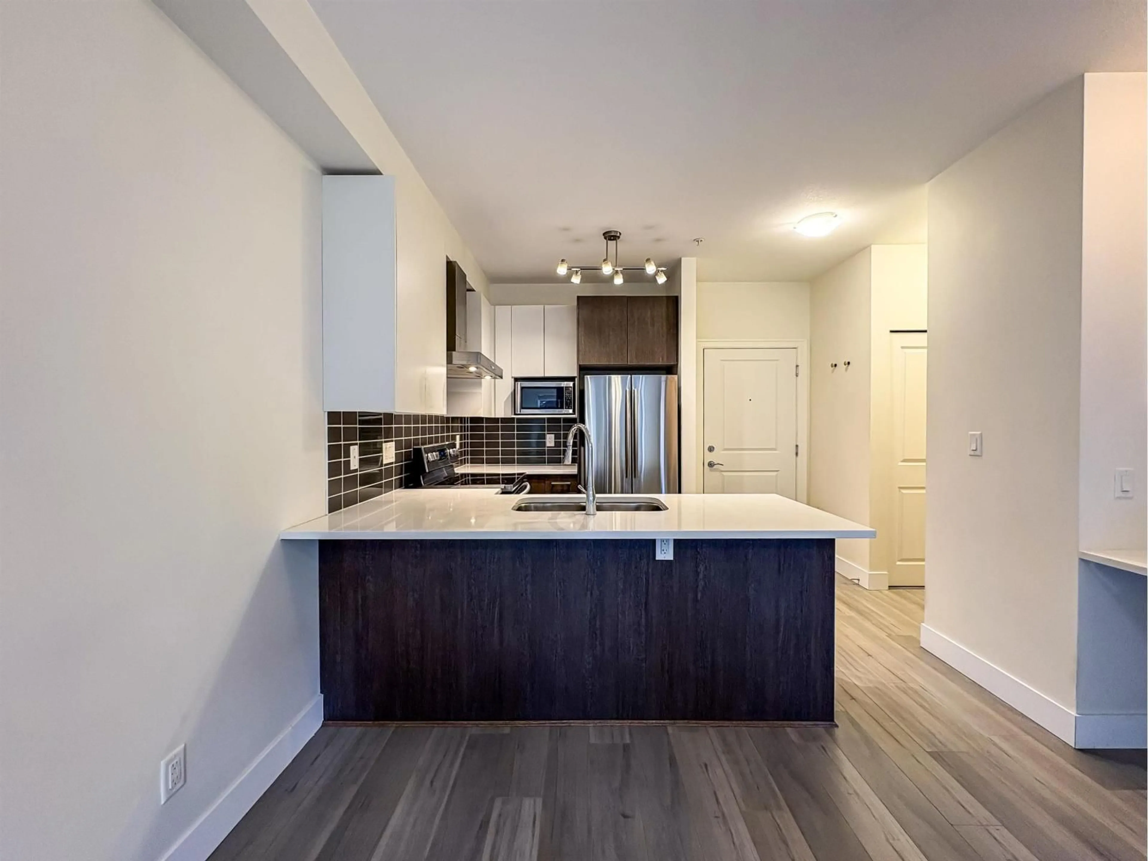 Open concept kitchen, wood/laminate floor for 213 - 6480 195A, Surrey British Columbia V4N6P1