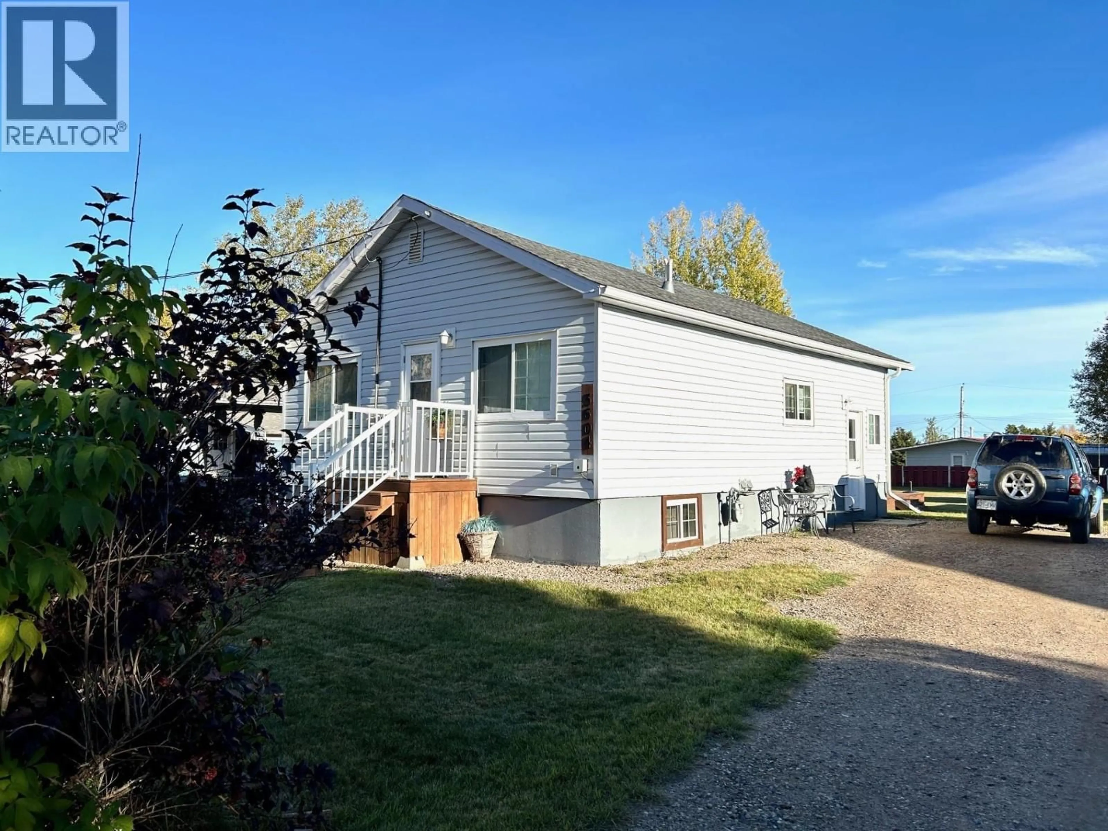 Home with vinyl exterior material, street for 5604 49 STREET, Fort Nelson British Columbia V0C1R0