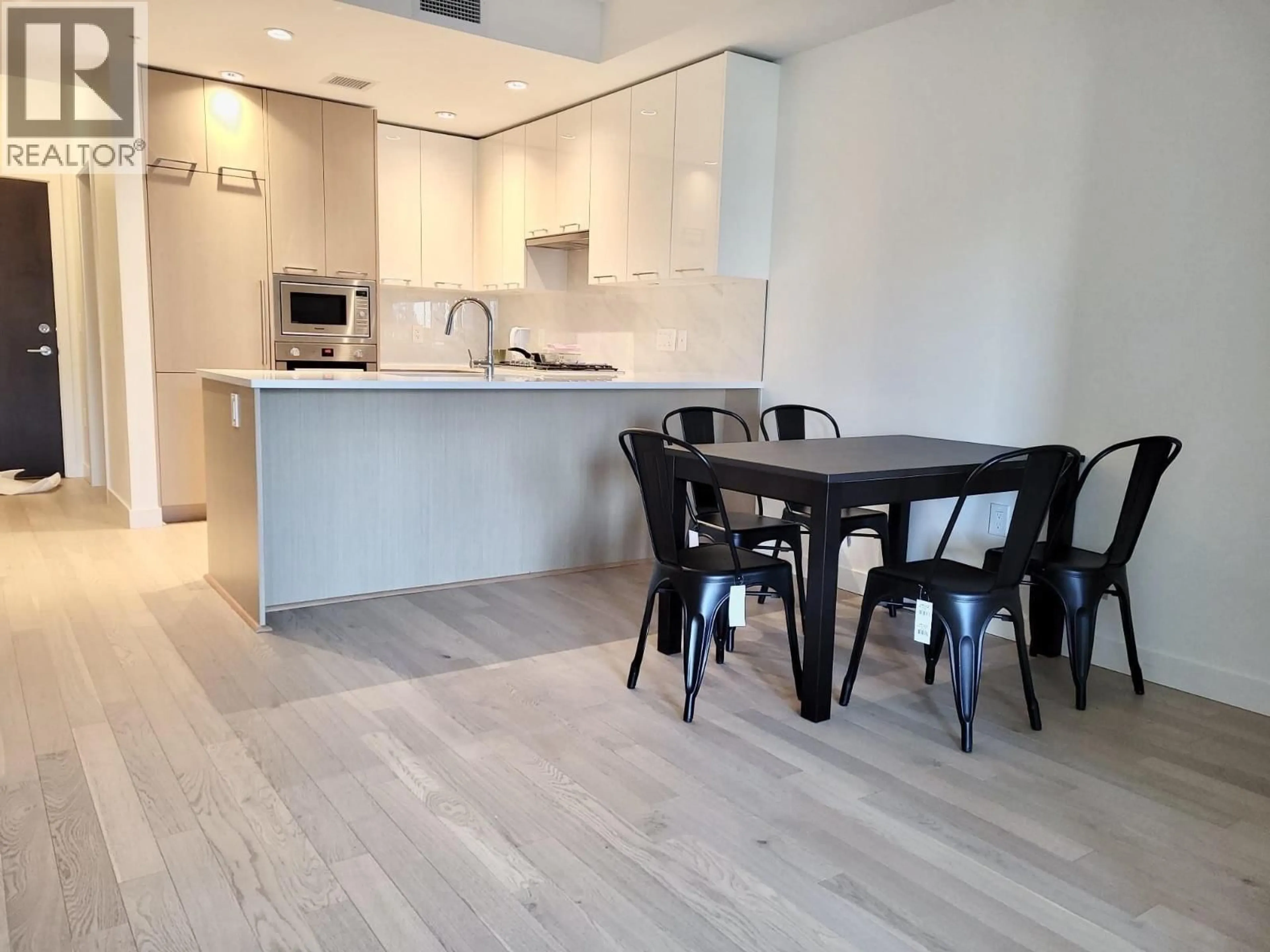 Open concept kitchen, wood/laminate floor for 221 - 4033 MAY DRIVE, Richmond British Columbia V6X0T3
