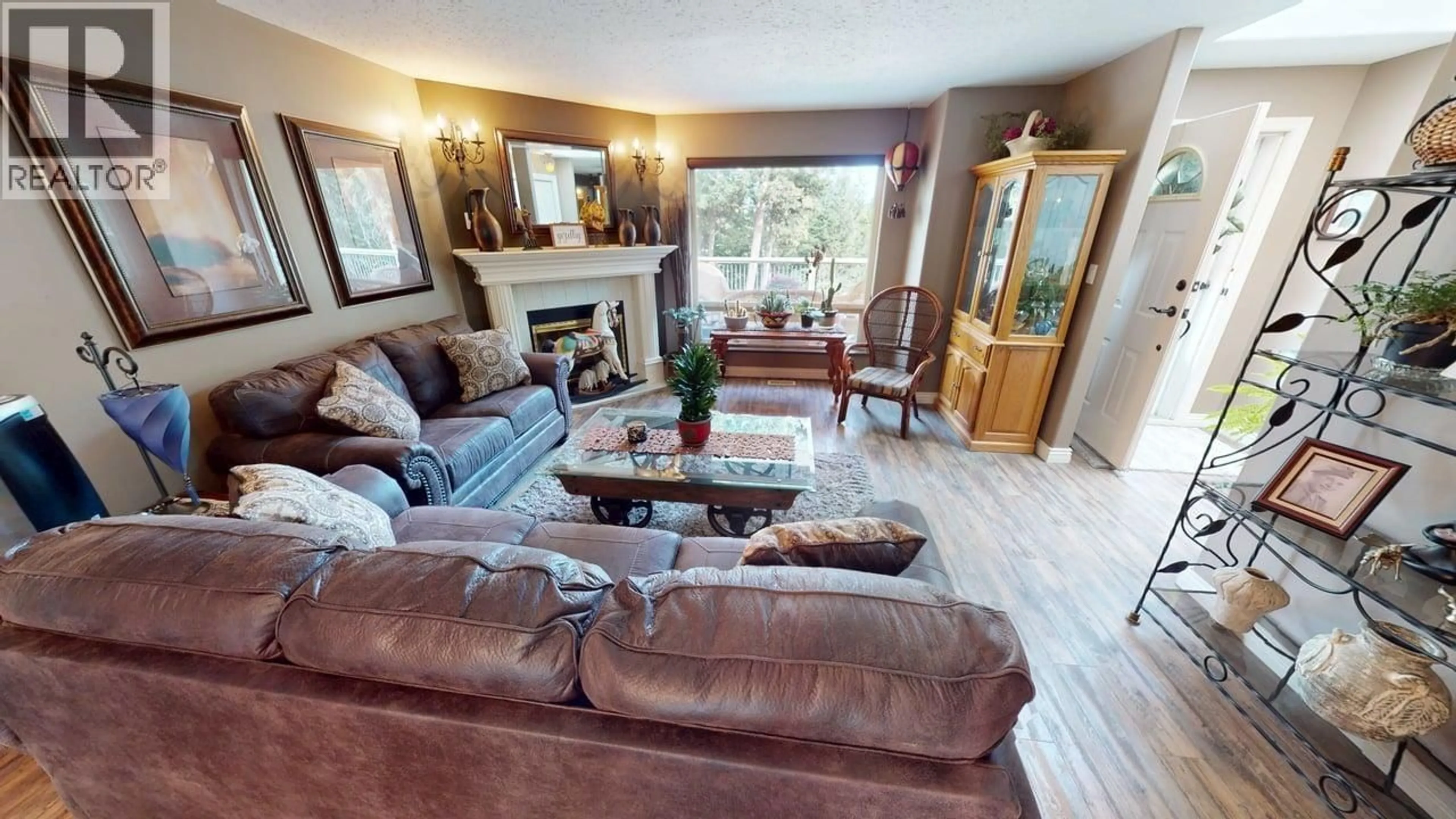 Living room with furniture, wood/laminate floor for 5270 MACKAY CRESCENT, 100 Mile House British Columbia V0K2Z0