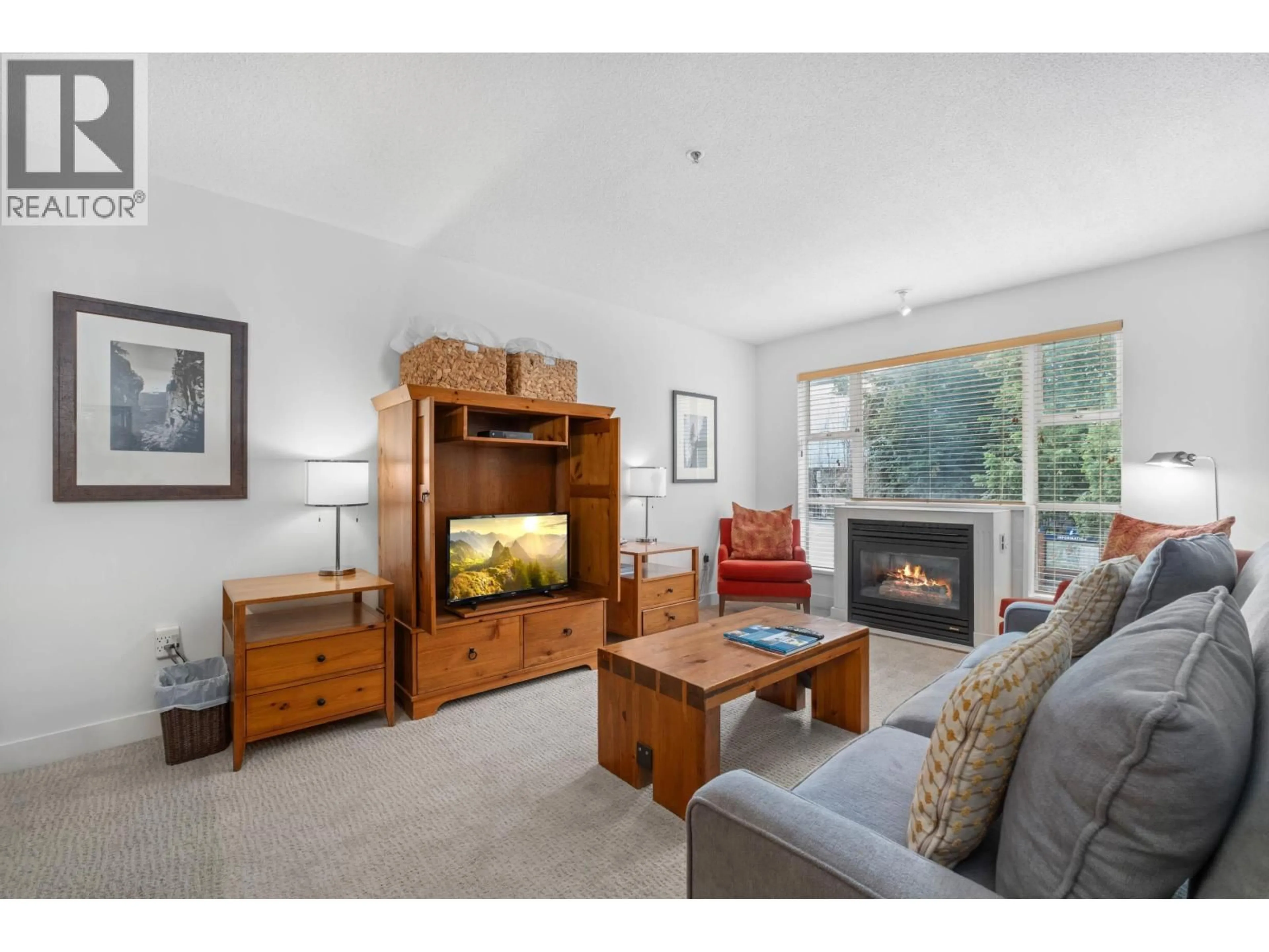 Living room with furniture, wood/laminate floor for 218/219 - 4573 CHATEAU BOULEVARD, Whistler British Columbia V0N1B4