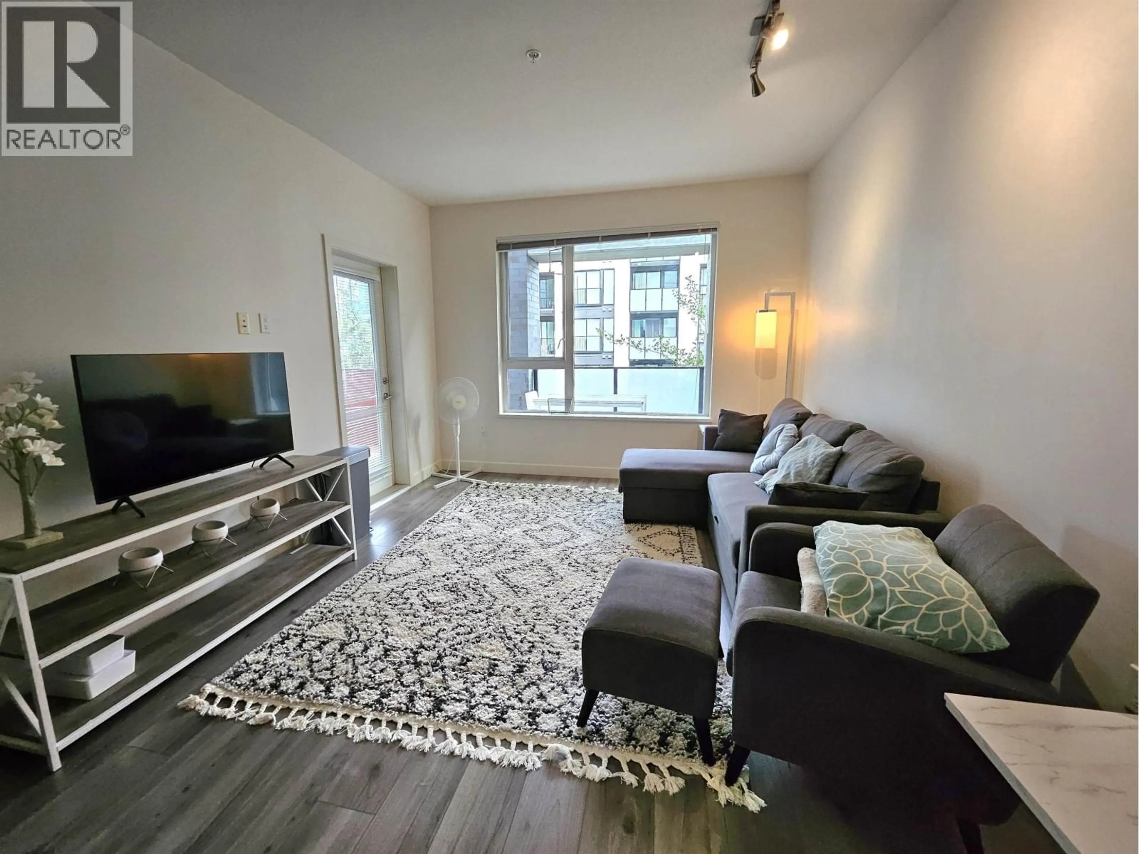 Living room with furniture, unknown for 209 - 9250 UNIVERSITY HIGH STREET, Burnaby British Columbia V5A0B3