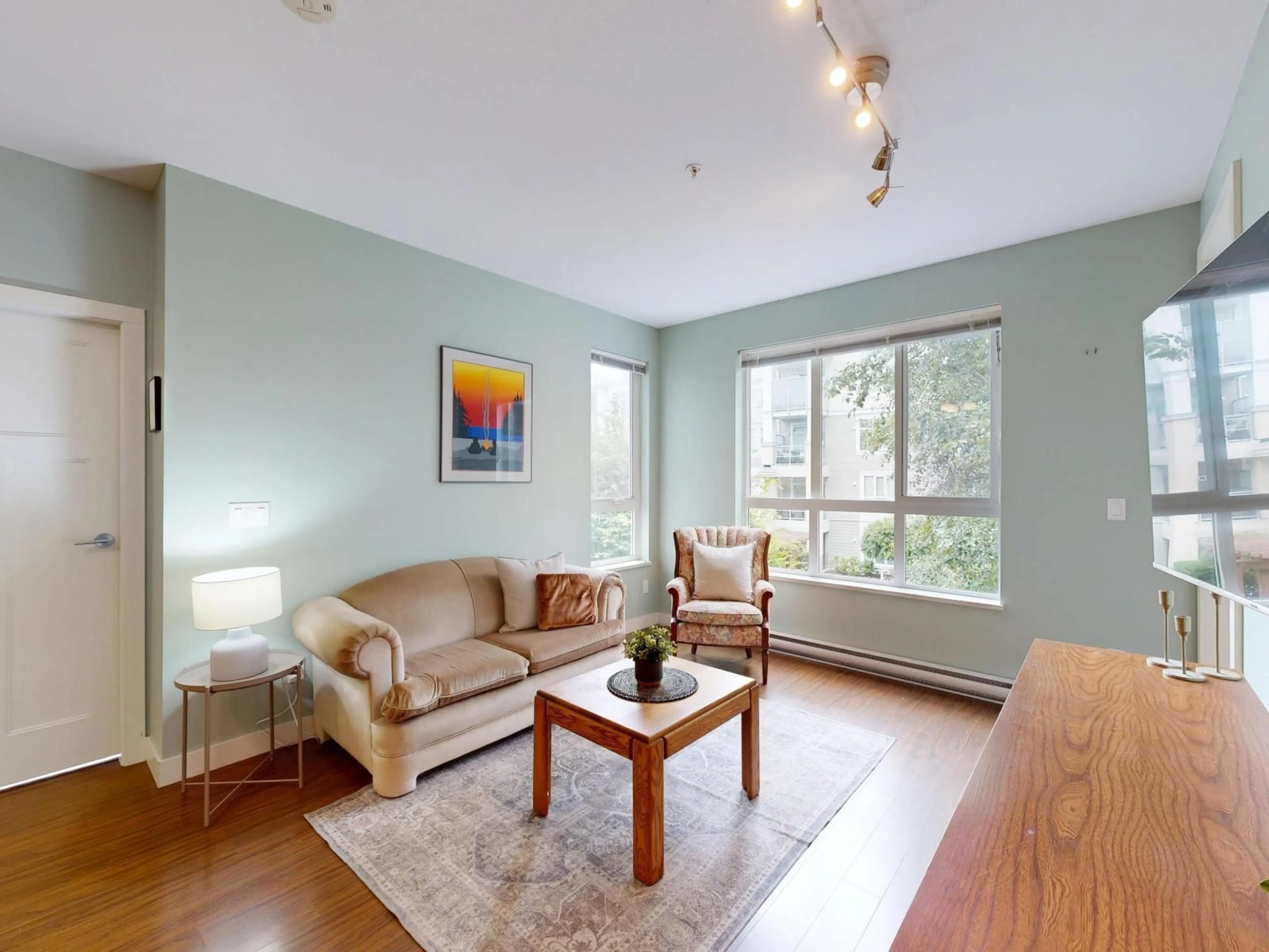 Living room with furniture, wood/laminate floor for 213 - 15428 31, Surrey British Columbia V3Z3W4