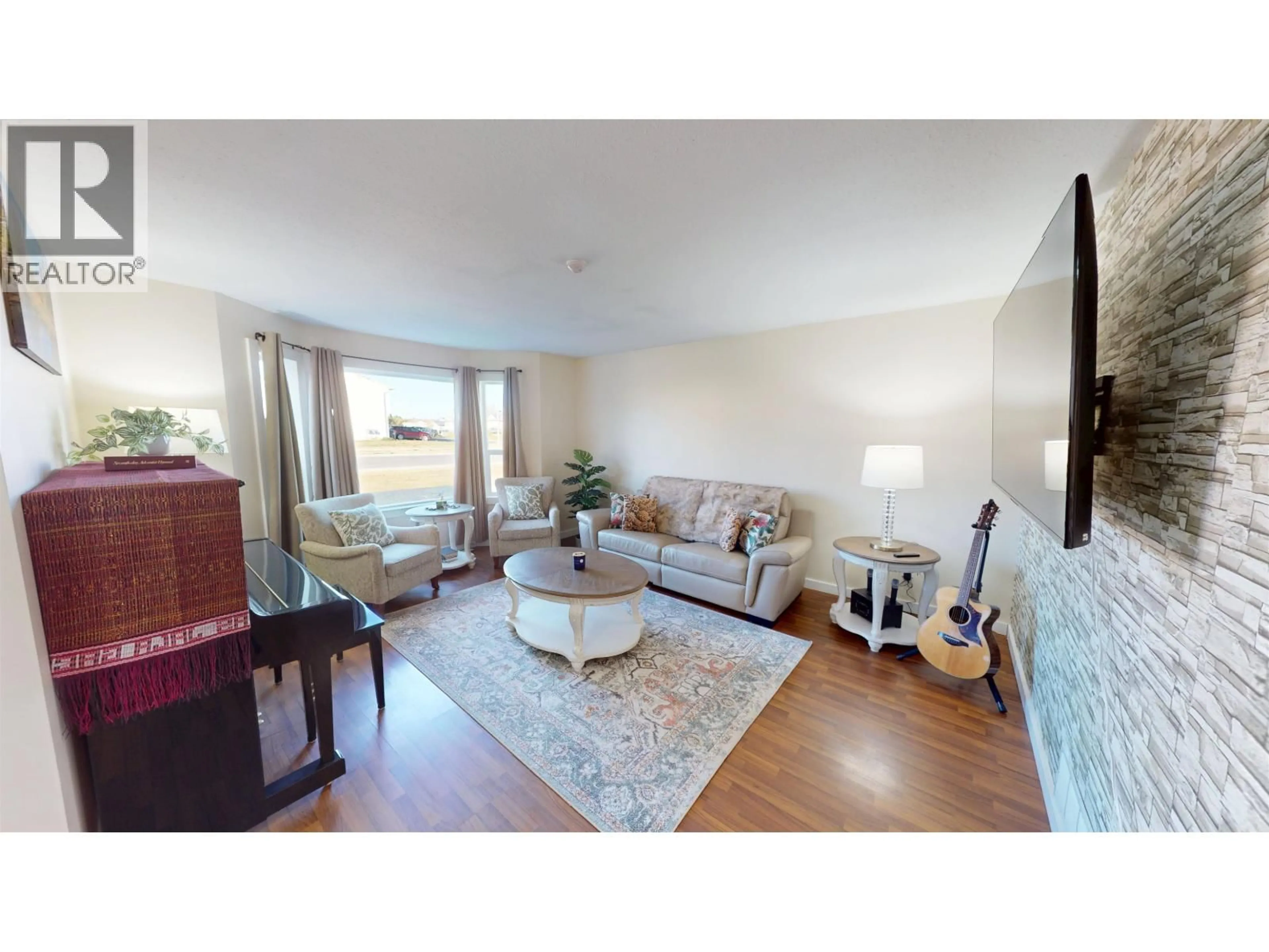 Living room with furniture, wood/laminate floor for 8019 89 AVENUE, Fort St. John British Columbia V1J6V6