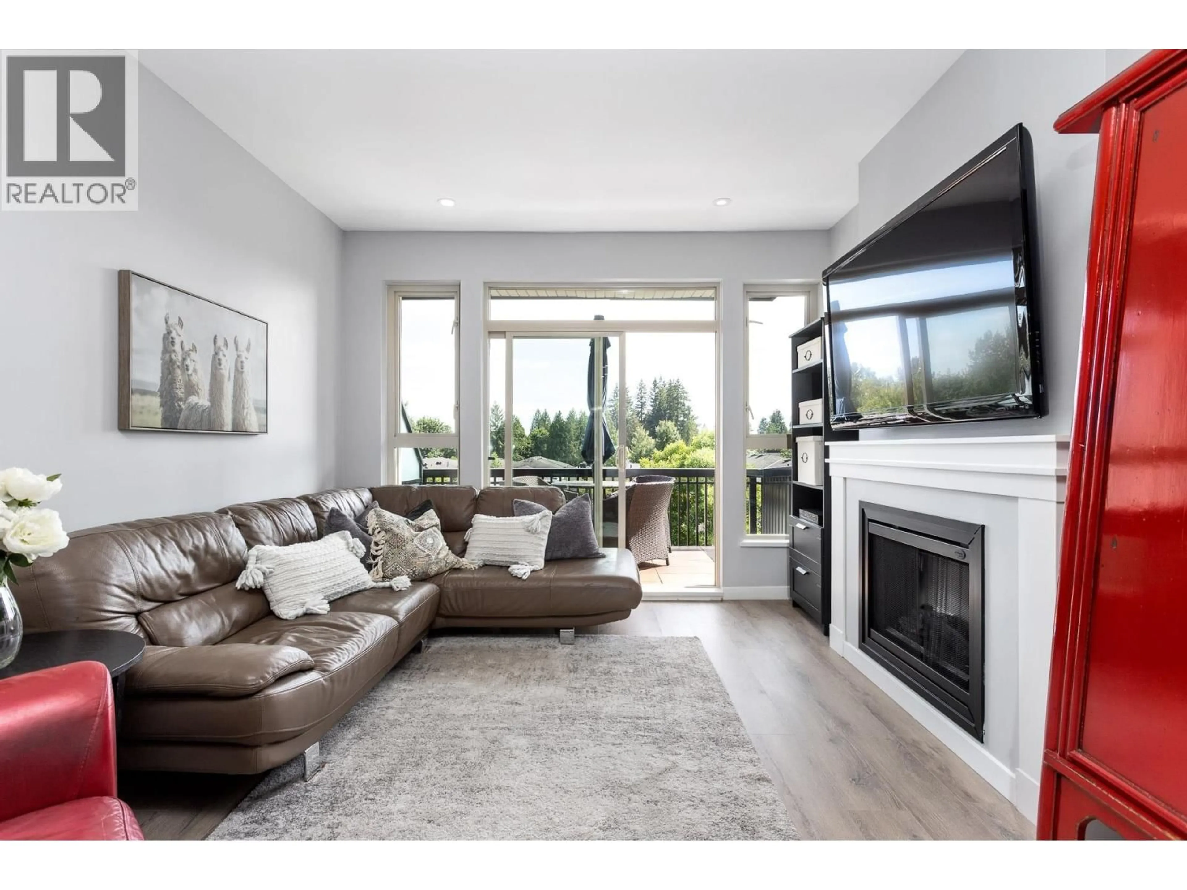 Living room with furniture, wood/laminate floor for 409 - 1153 KENSAL PLACE, Coquitlam British Columbia V3B0G8