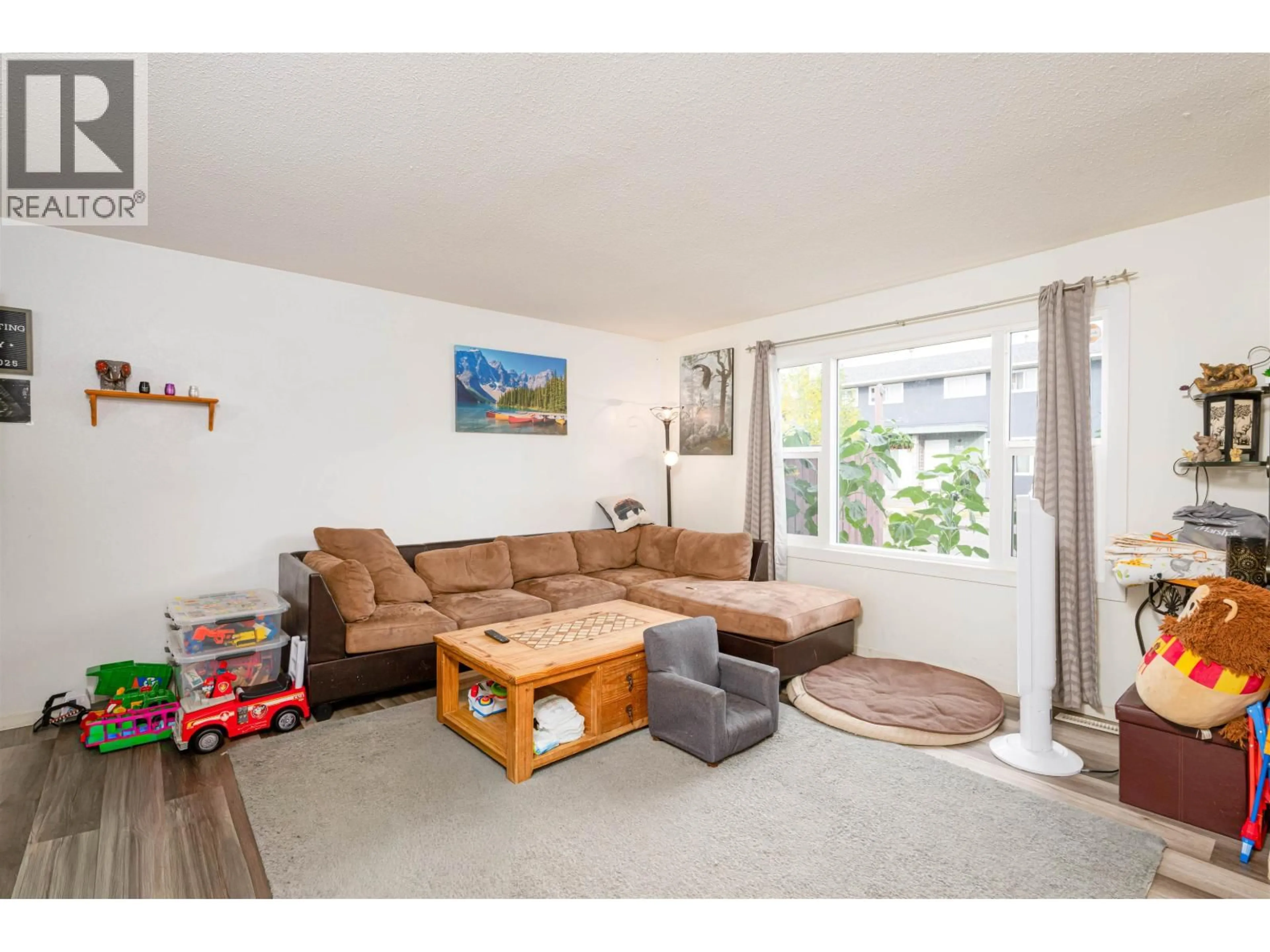 Living room with furniture, wood/laminate floor for H126 - 1900 STRATHCONA AVENUE, Prince George British Columbia V2L2V9