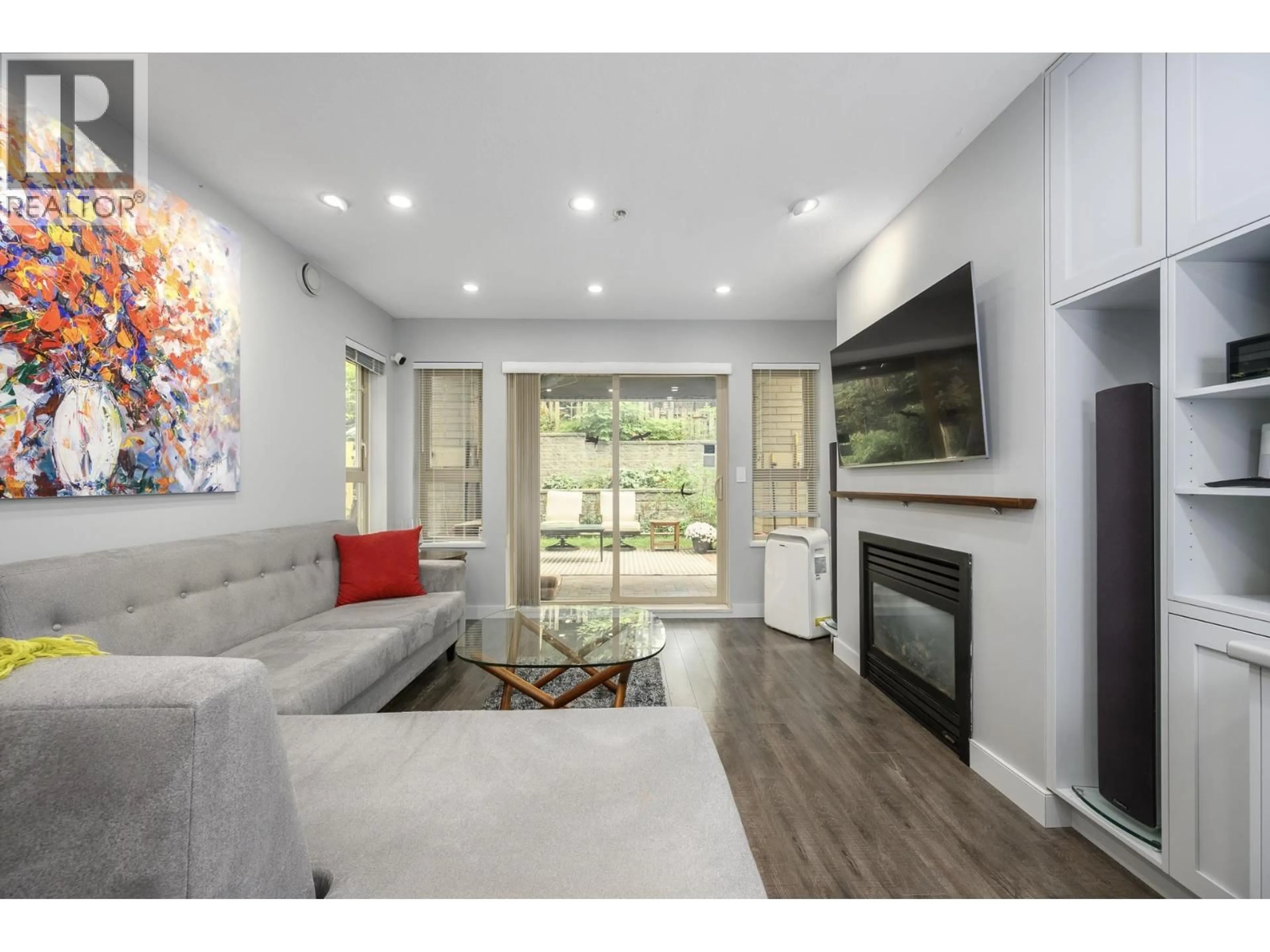 Living room with furniture, wood/laminate floor for 210 - 9319 UNIVERSITY CRESCENT, Burnaby British Columbia V5A4Y5