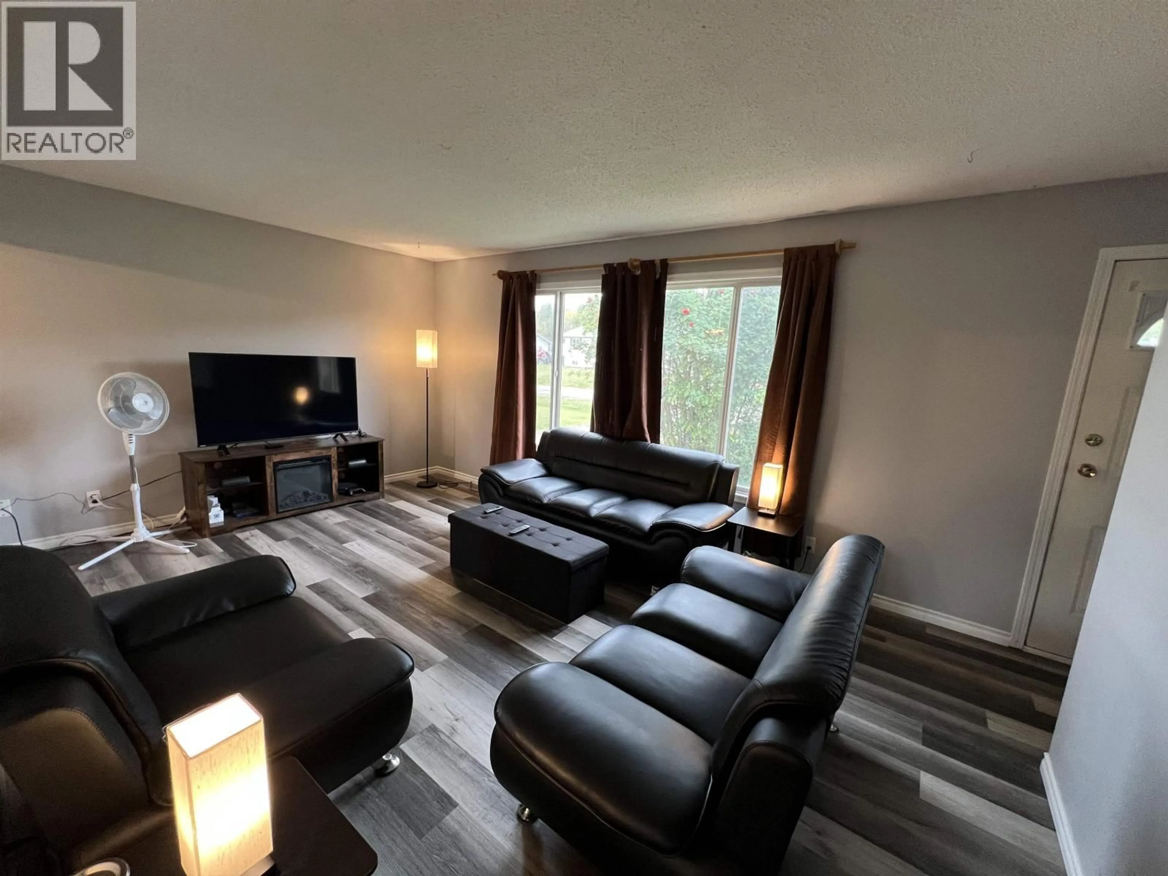 Living room with furniture, wood/laminate floor for 5524 48 STREET, Fort Nelson British Columbia V0C1R0