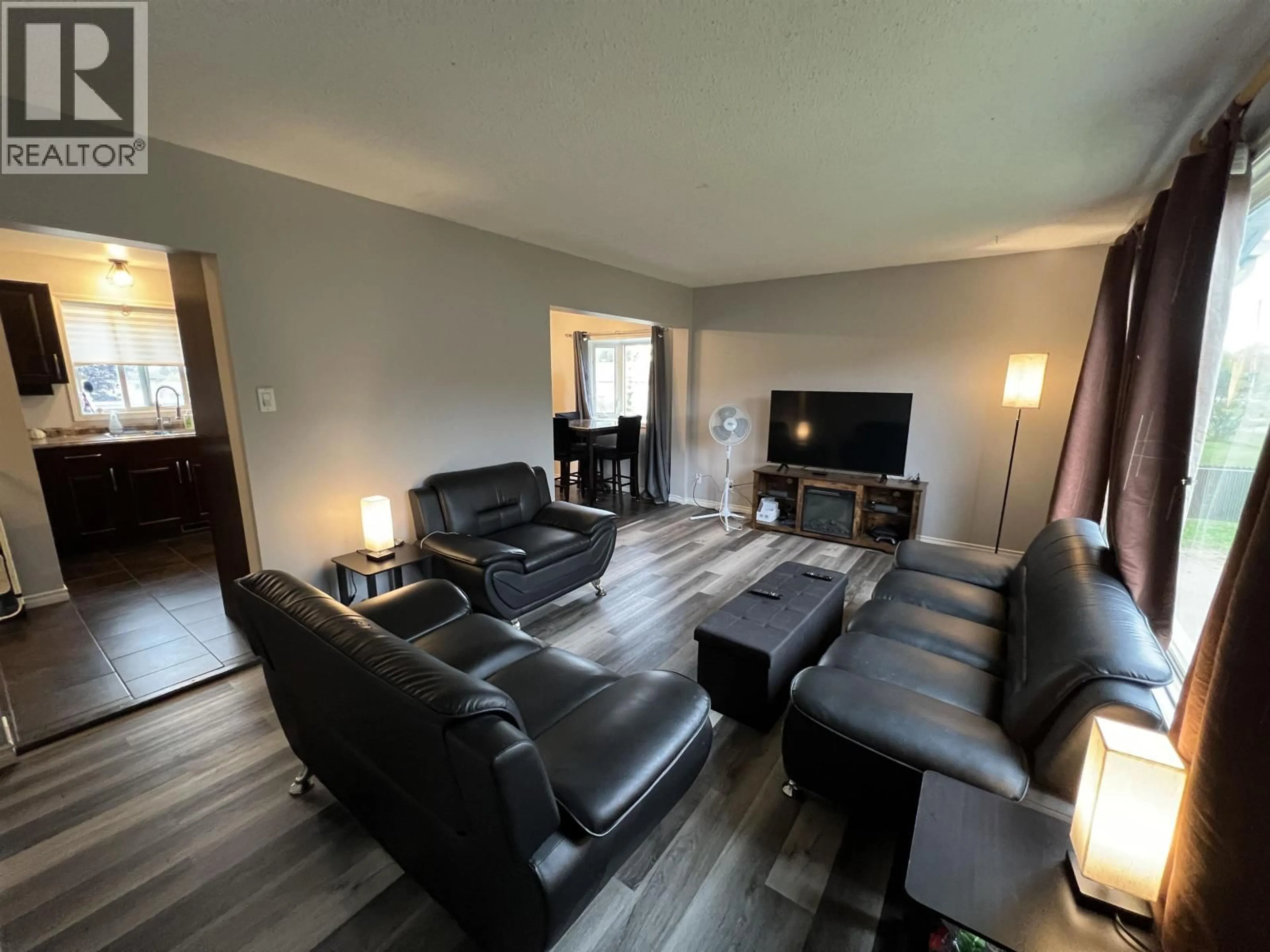 Living room with furniture, wood/laminate floor for 5524 48 STREET, Fort Nelson British Columbia V0C1R0