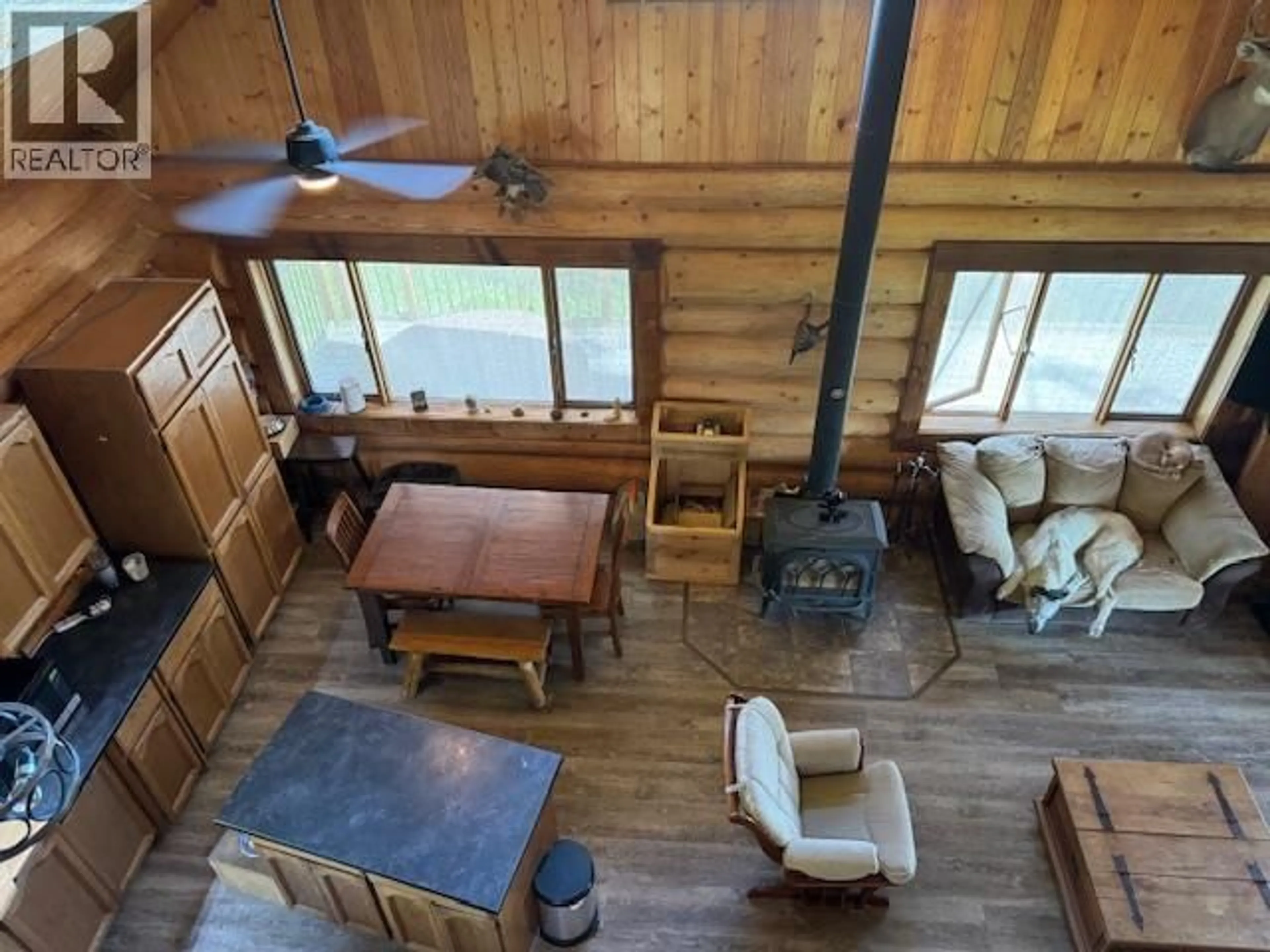 Living room with furniture, wood/laminate floor for 7742 BRIDGE LAKE ROAD, Bridge Lake British Columbia V0K1X2