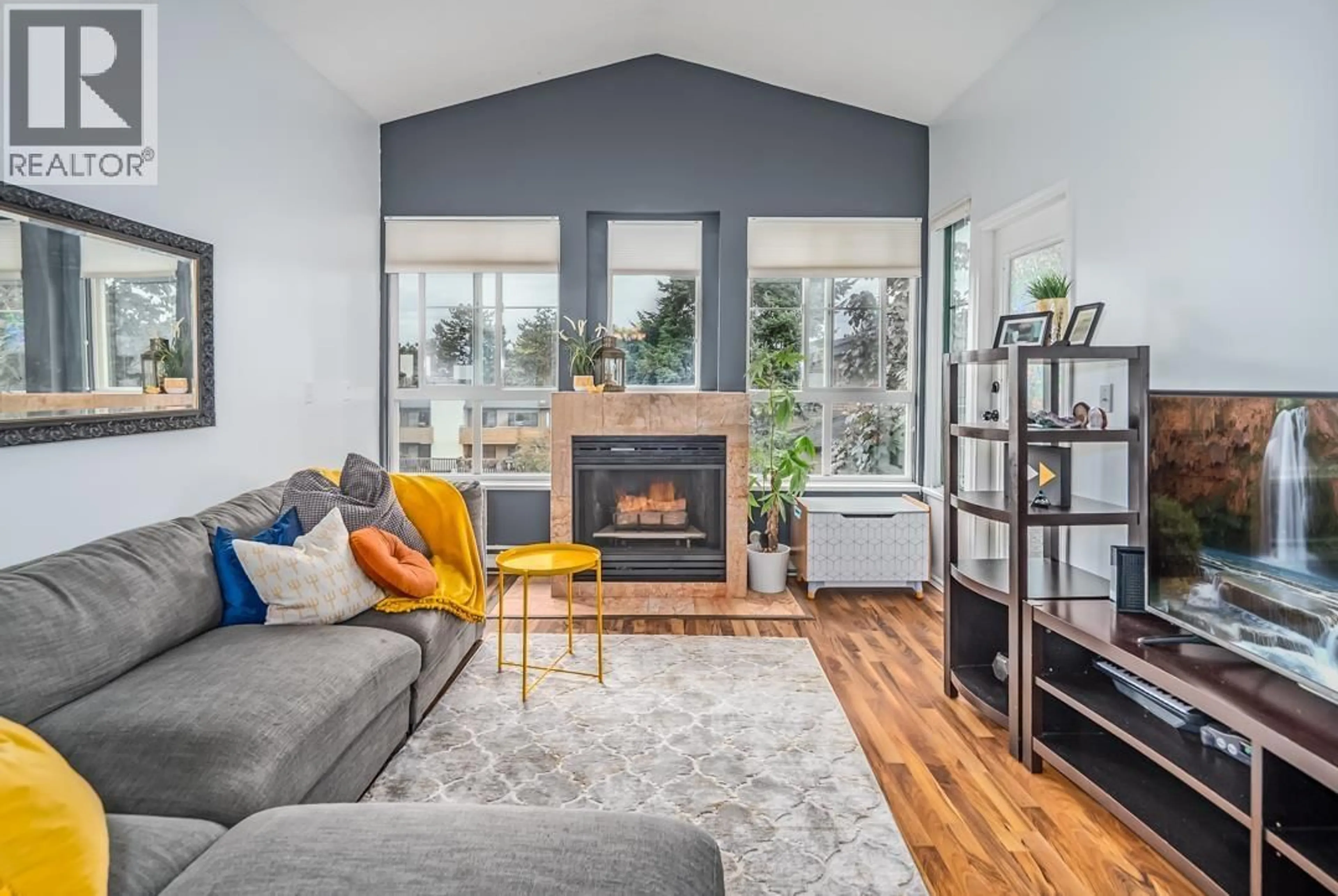 Living room with furniture, wood/laminate floor for 306 - 7300 GILBERT ROAD, Richmond British Columbia V7C3W2