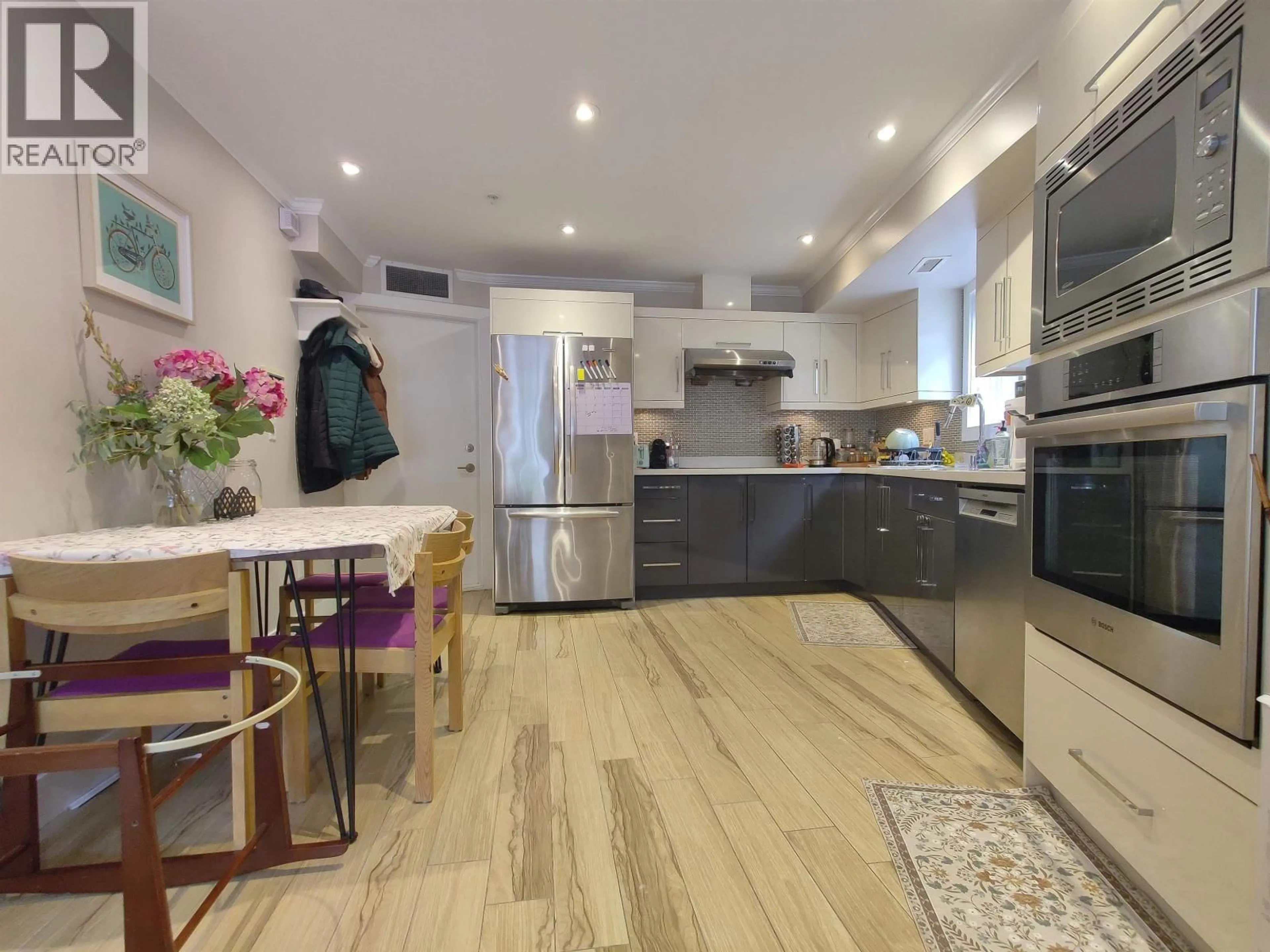 Open concept kitchen, wood/laminate floor for 2055 TRIUMPH STREET, Vancouver British Columbia V5L1K7