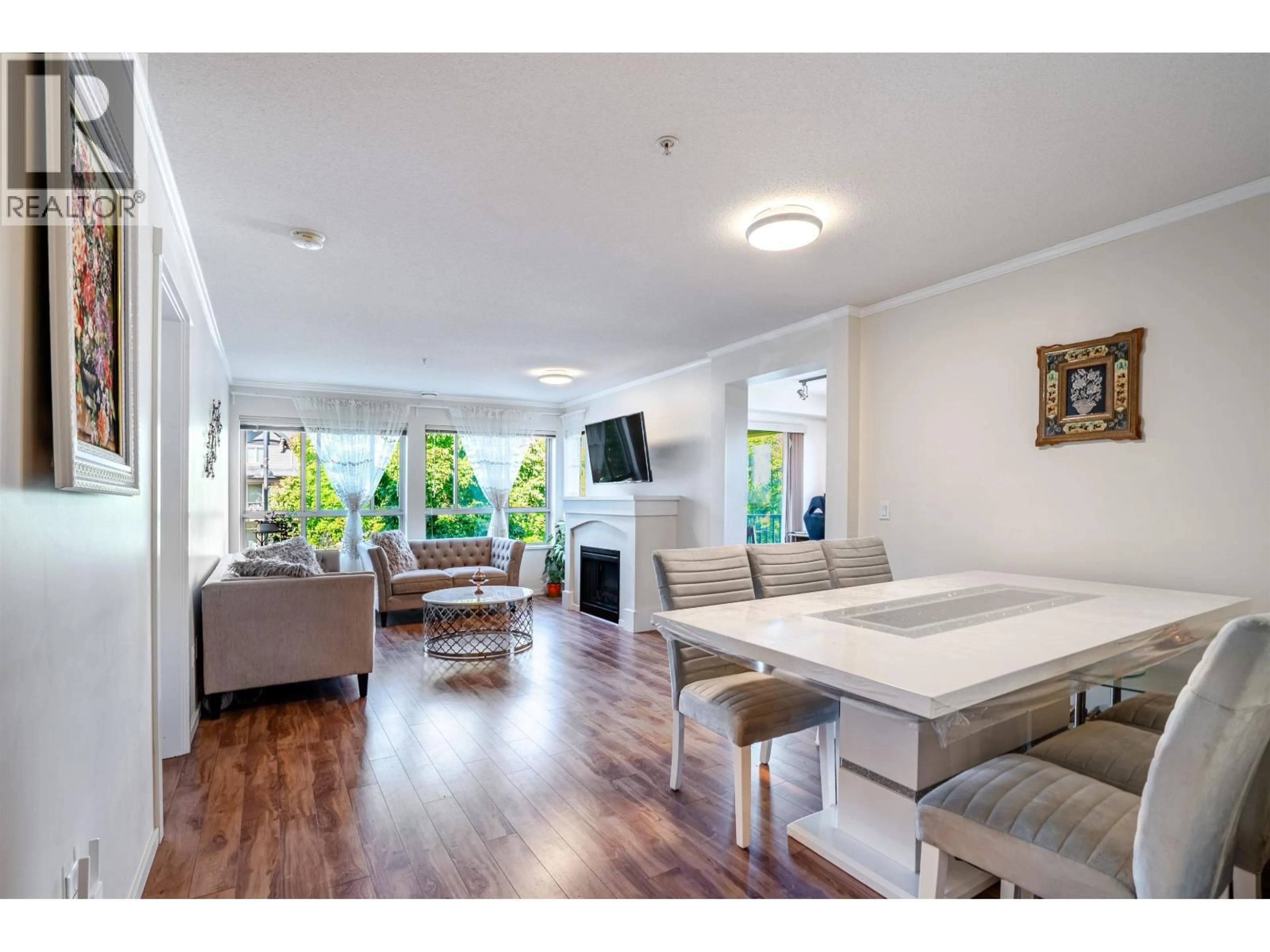 Living room with furniture, wood/laminate floor for 303 - 3110 DAYANEE SPRINGS BOULEVARD, Coquitlam British Columbia V3E0B4