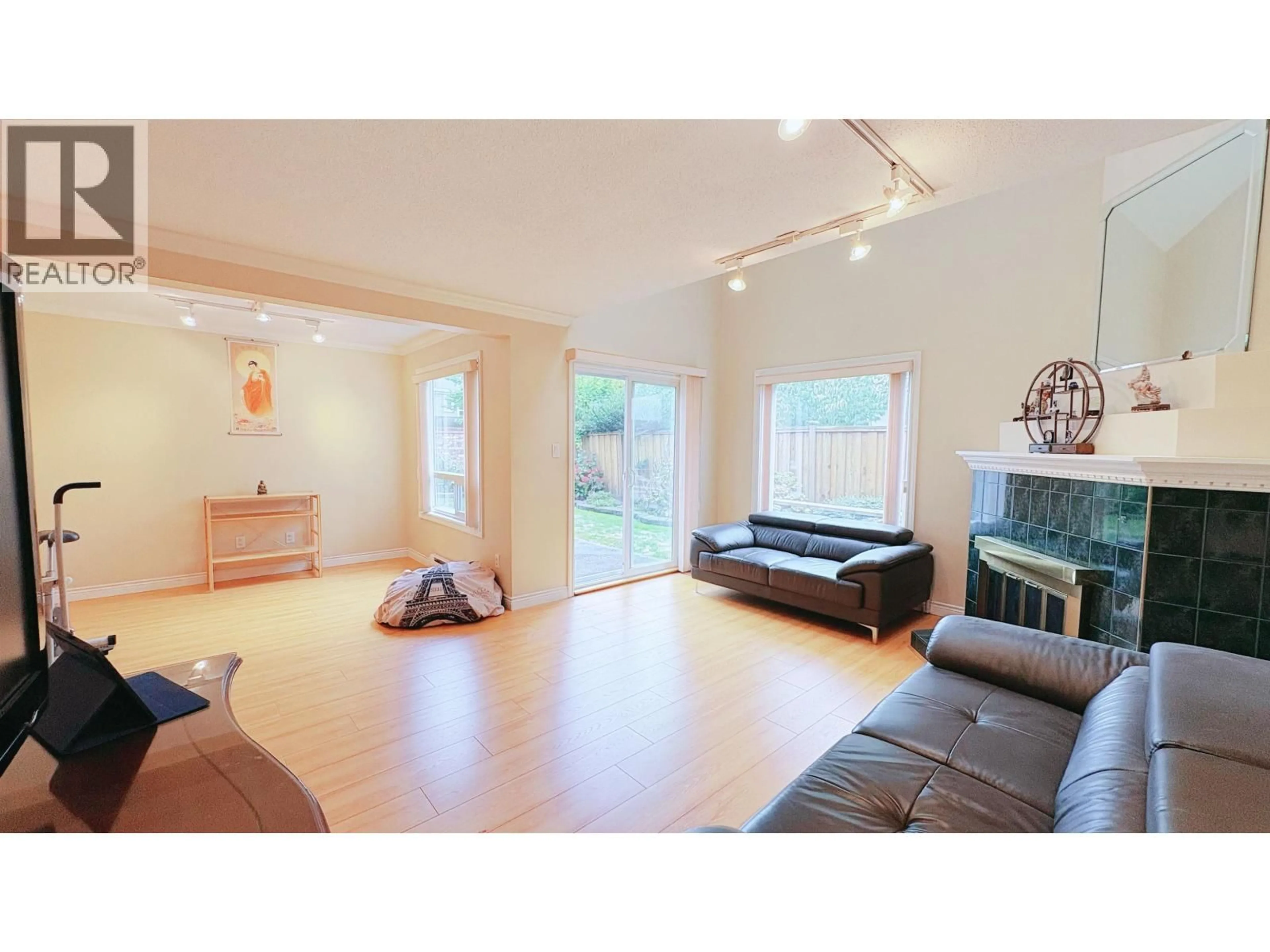 Living room with furniture, wood/laminate floor for 11 - 8631 NO.3 ROAD, Richmond British Columbia V6Y2E6