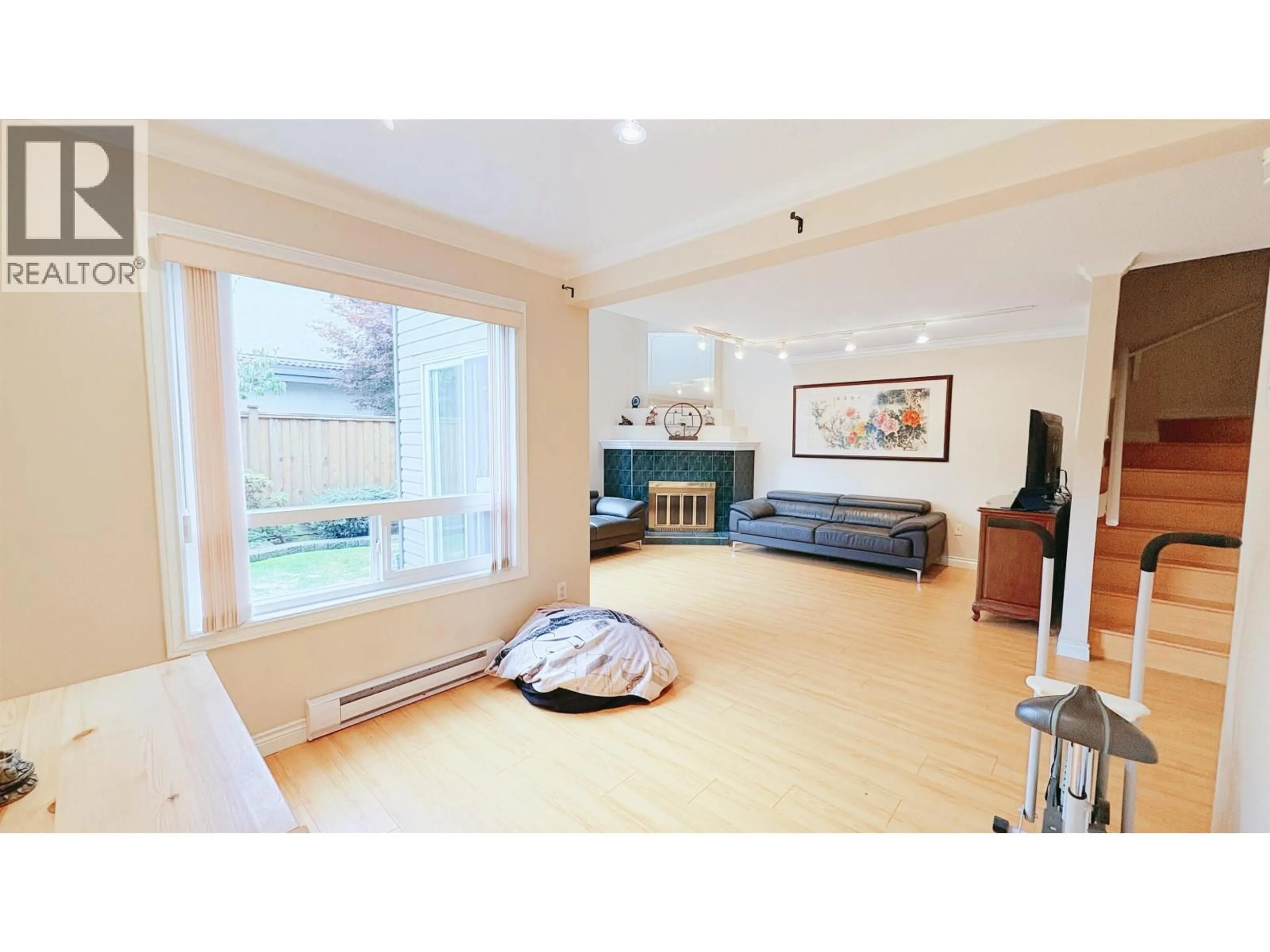 Living room with furniture, wood/laminate floor for 11 - 8631 NO.3 ROAD, Richmond British Columbia V6Y2E6