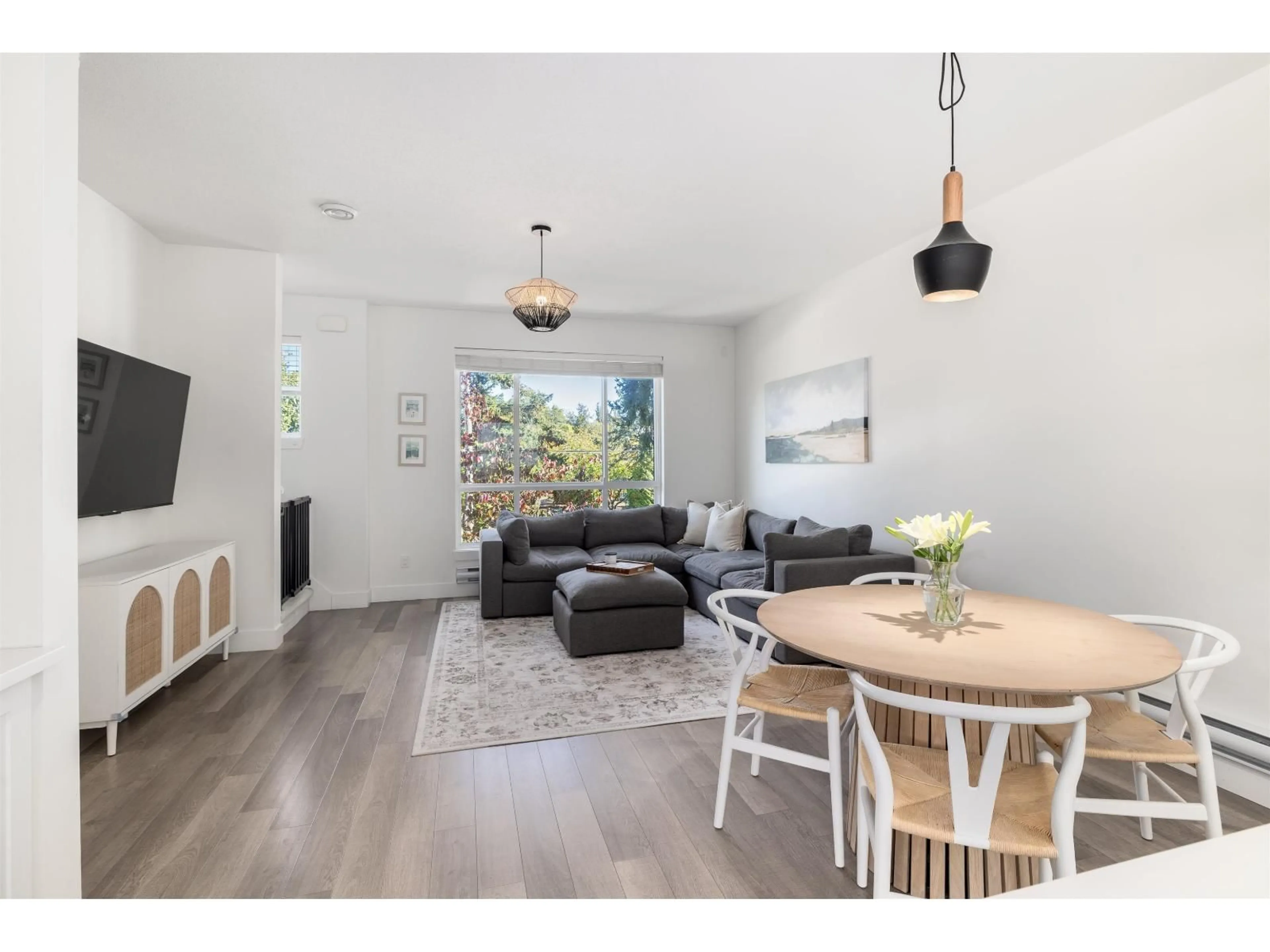 Living room with furniture, wood/laminate floor for 22 - 16760 25, Surrey British Columbia V3Z0W4