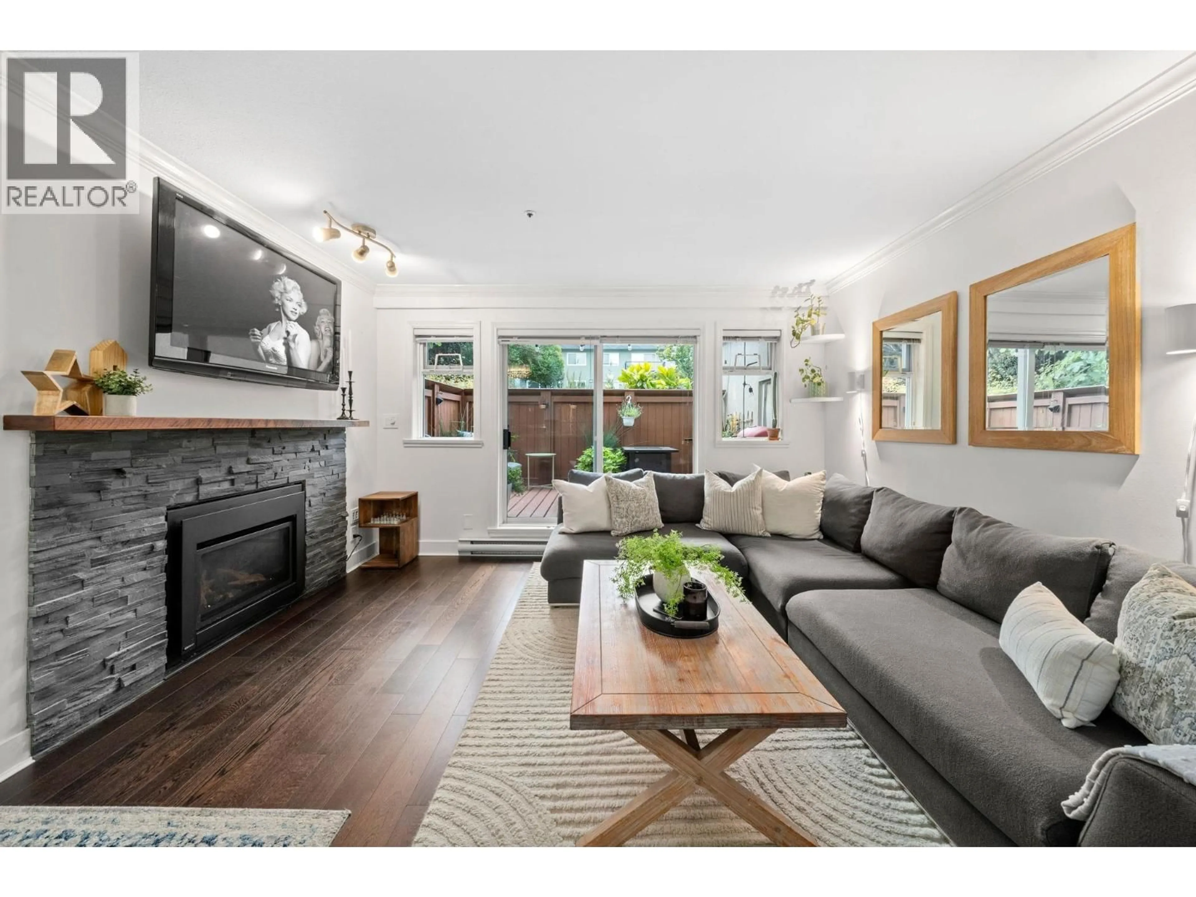 Living room with furniture, wood/laminate floor for 101 - 2215 MCGILL STREET, Vancouver British Columbia V5L1C3