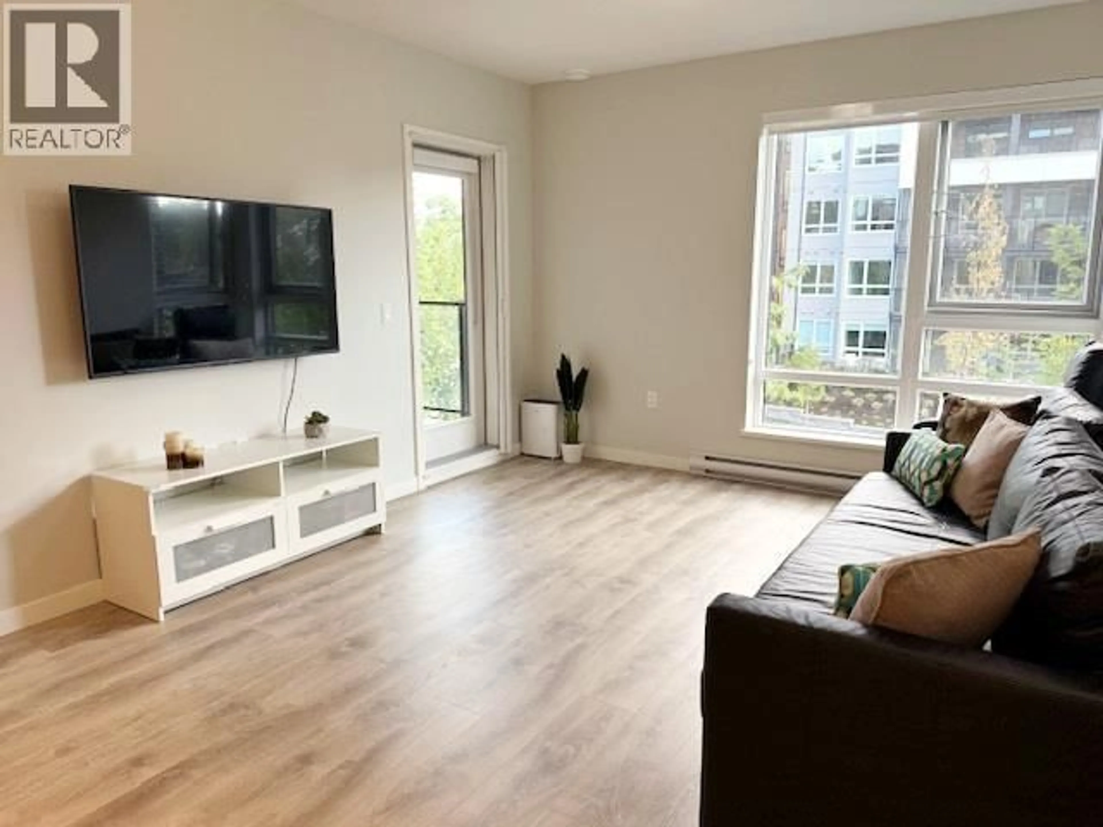 Living room with furniture, wood/laminate floor for 408 - 615 COTTONWOOD AVENUE, Coquitlam British Columbia V3J0N4