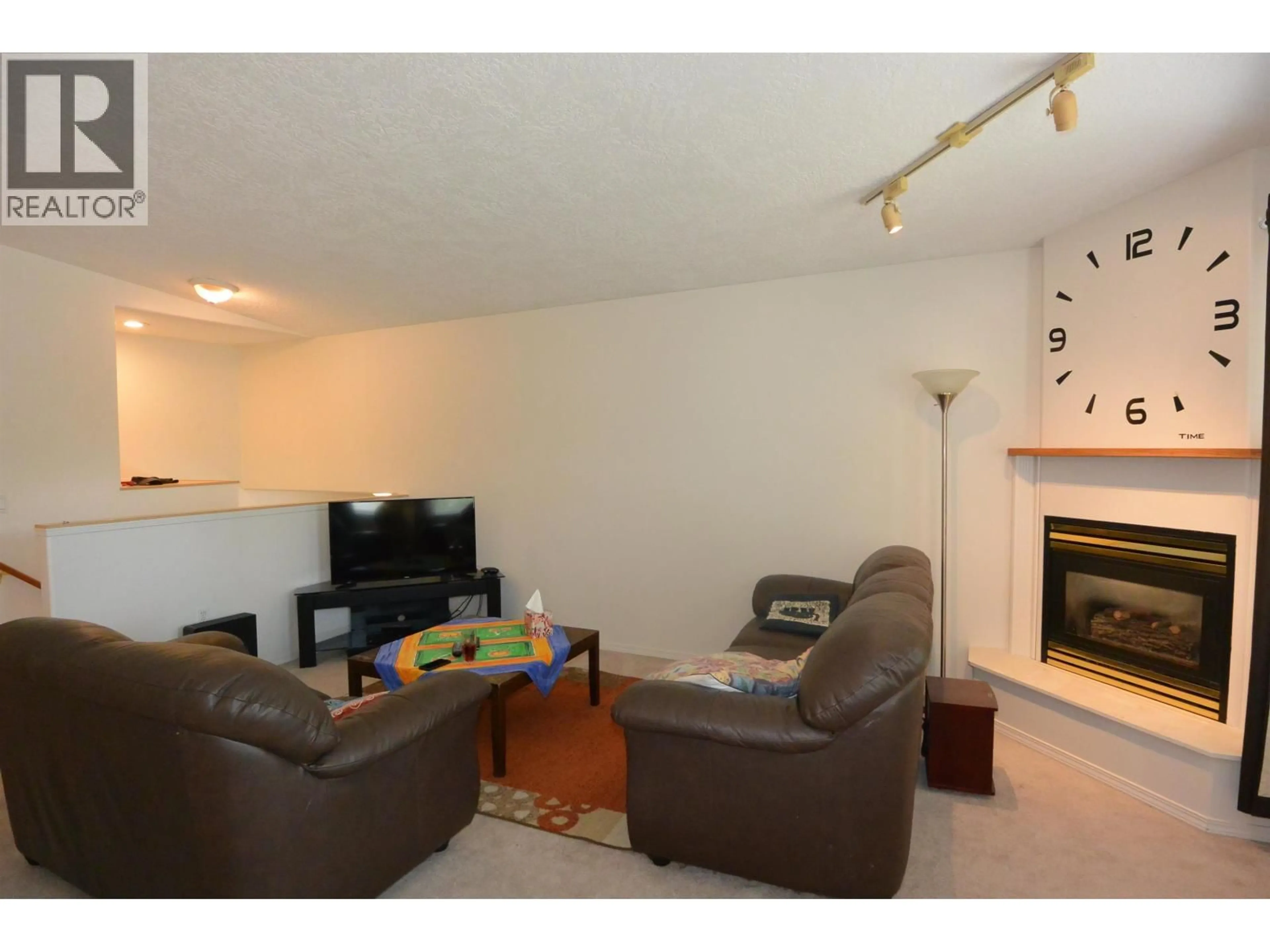 Living room with furniture, wood/laminate floor for 1276 DOMINION STREET, Smithers British Columbia V0J2N0