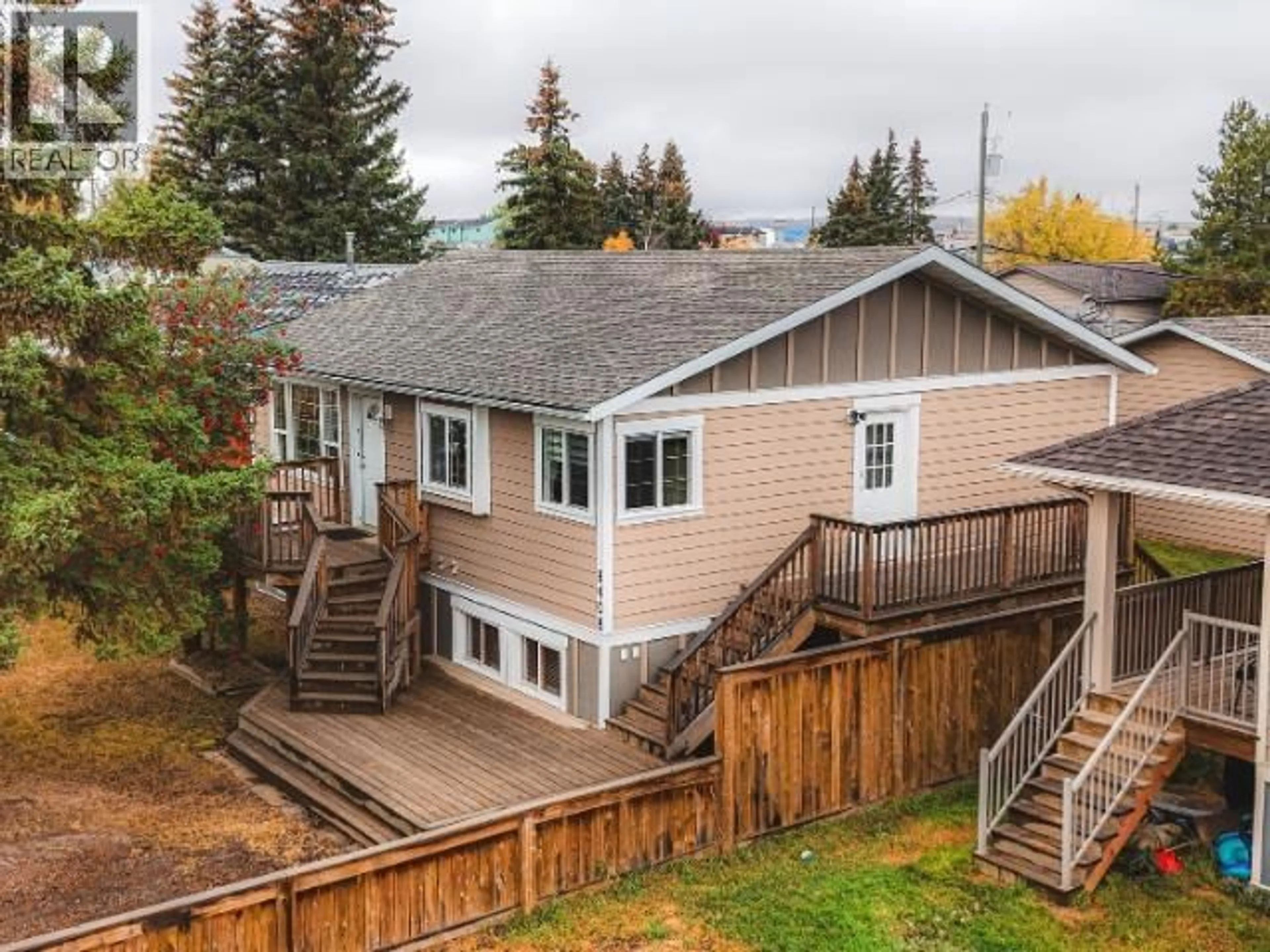 A pic from outside/outdoor area/front of a property/back of a property/a pic from drone, mountain view for 8408 97 AVENUE, Fort St. John British Columbia V1J1M4