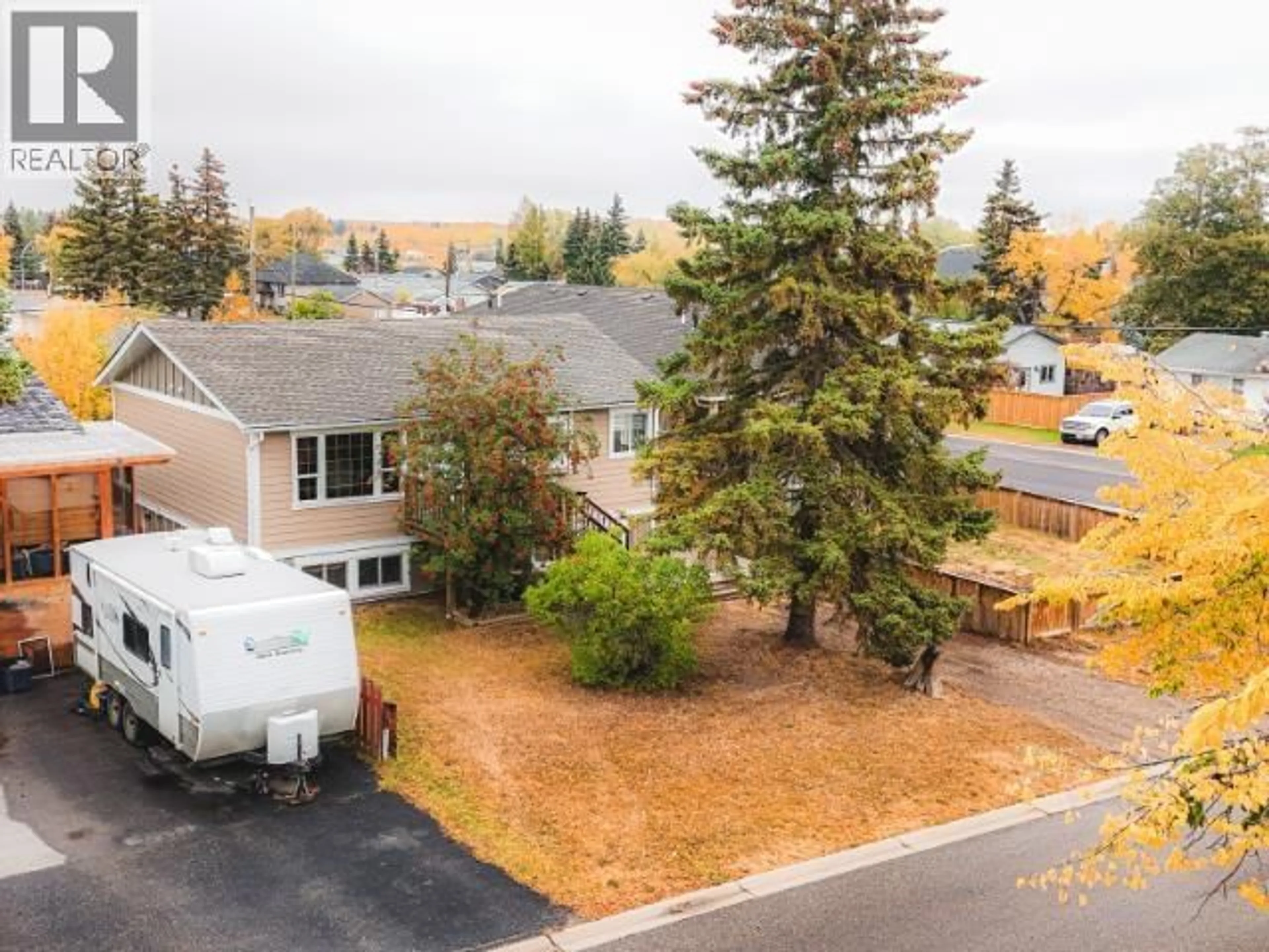 A pic from outside/outdoor area/front of a property/back of a property/a pic from drone, mountain view for 8408 97 AVENUE, Fort St. John British Columbia V1J1M4