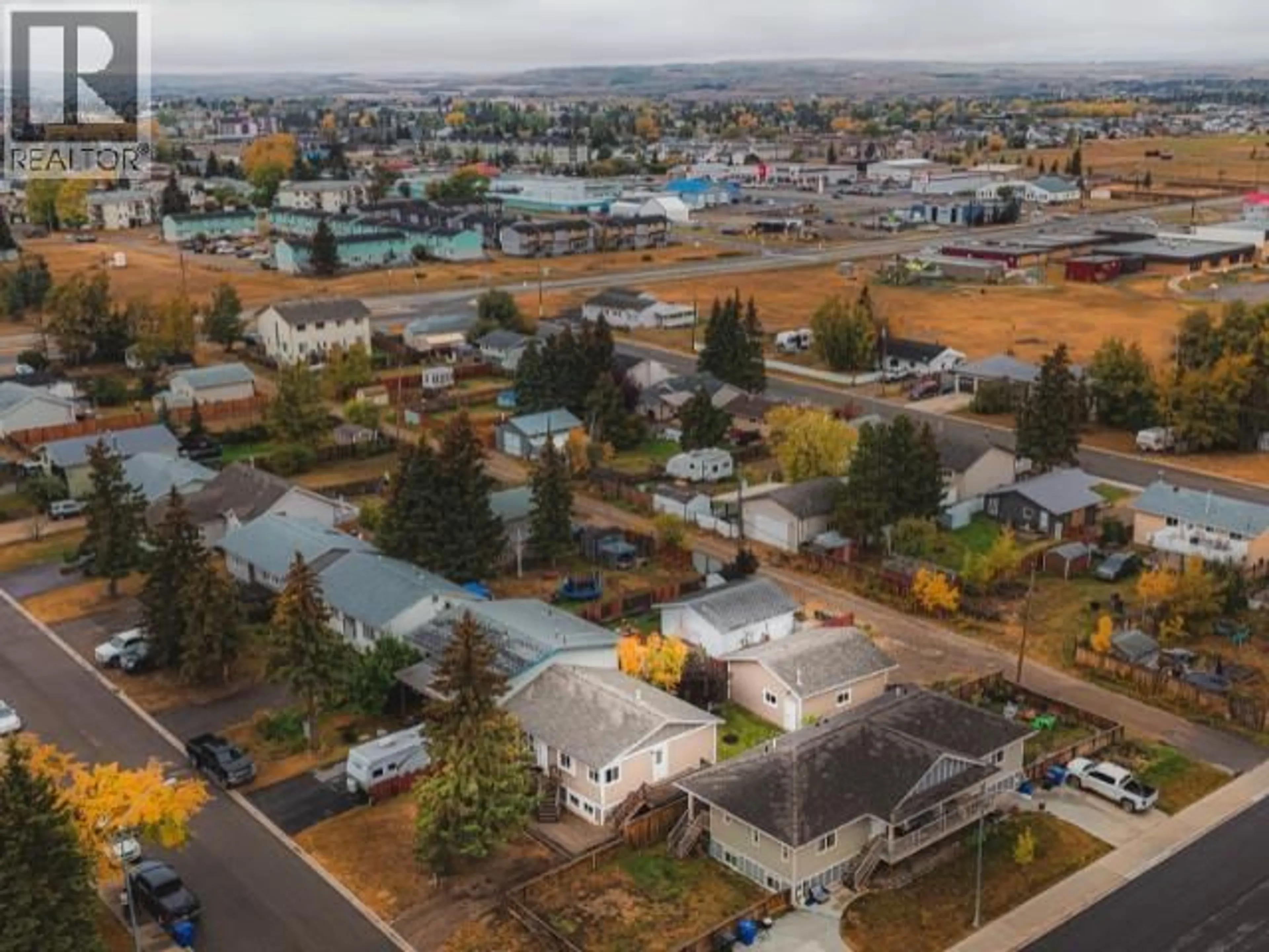 A pic from outside/outdoor area/front of a property/back of a property/a pic from drone, mountain view for 8408 97 AVENUE, Fort St. John British Columbia V1J1M4