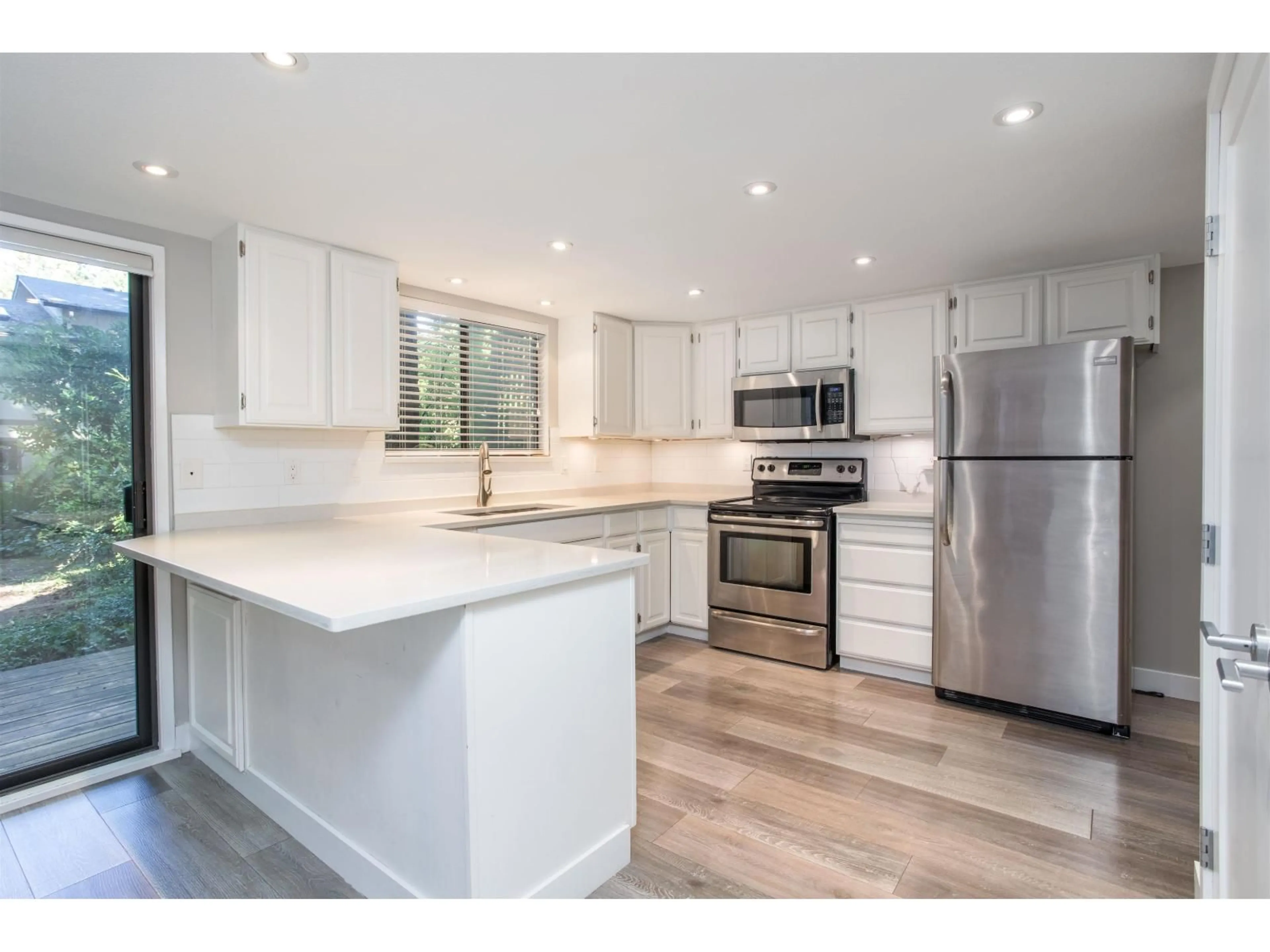Open concept kitchen, wood/laminate floor for 103 - 12743 16, Surrey British Columbia V4A1N2