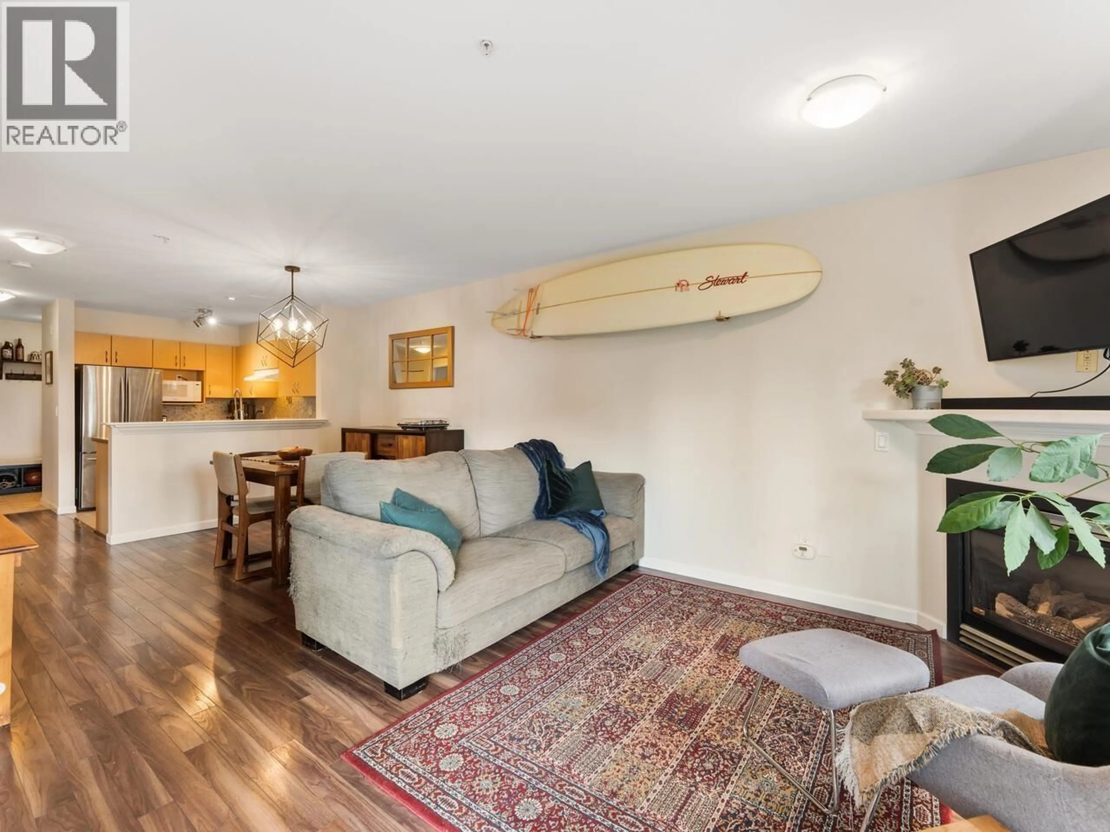 Living room with furniture, wood/laminate floor for 218 - 147 1ST STREET, North Vancouver British Columbia V7L1B2