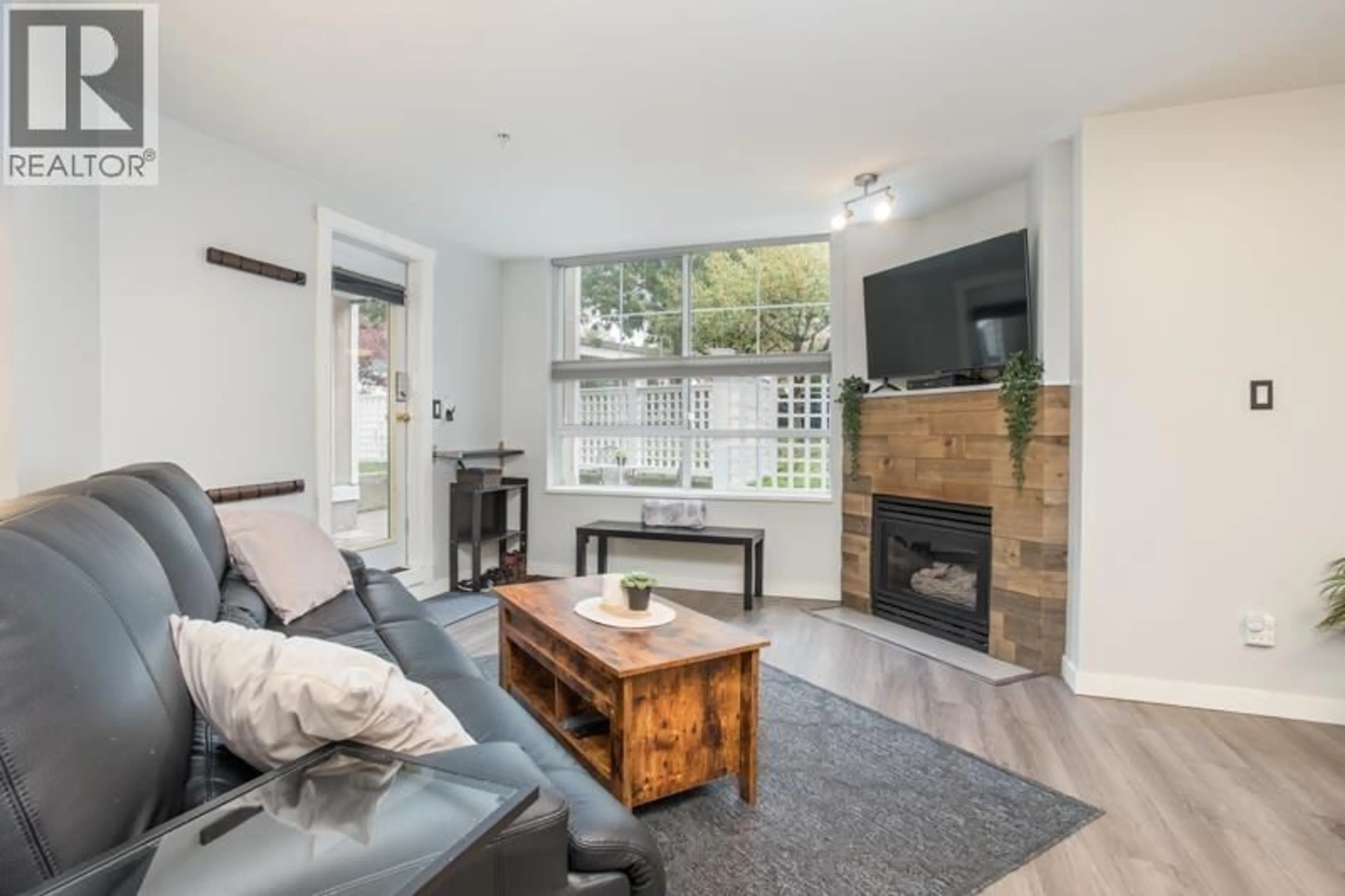 Living room with furniture, wood/laminate floor for 108 - 7117 ANTRIM AVENUE, Burnaby British Columbia V5J5K1