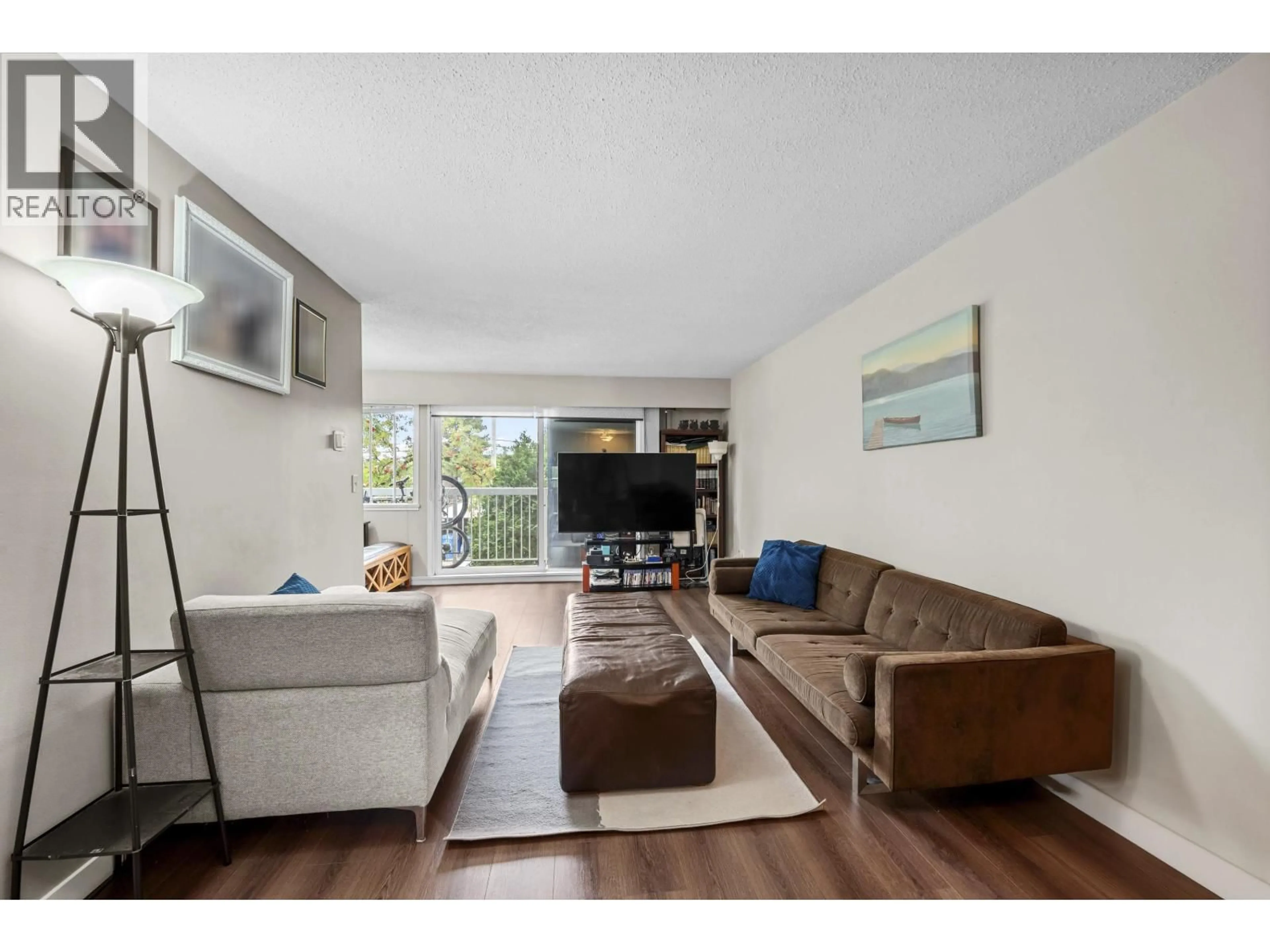 Living room with furniture, wood/laminate floor for 204 - 8020 RYAN ROAD, Richmond British Columbia V7A2E5
