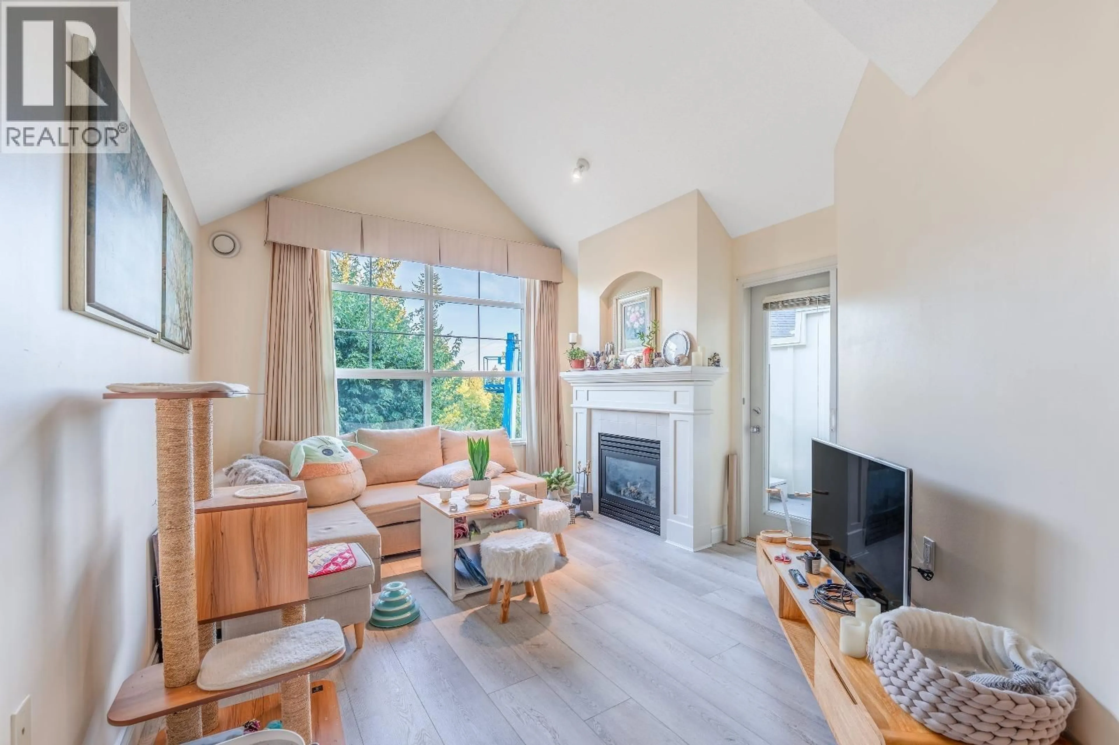 Living room with furniture, wood/laminate floor for 416 - 960 LYNN VALLEY ROAD, North Vancouver British Columbia V7J3V6