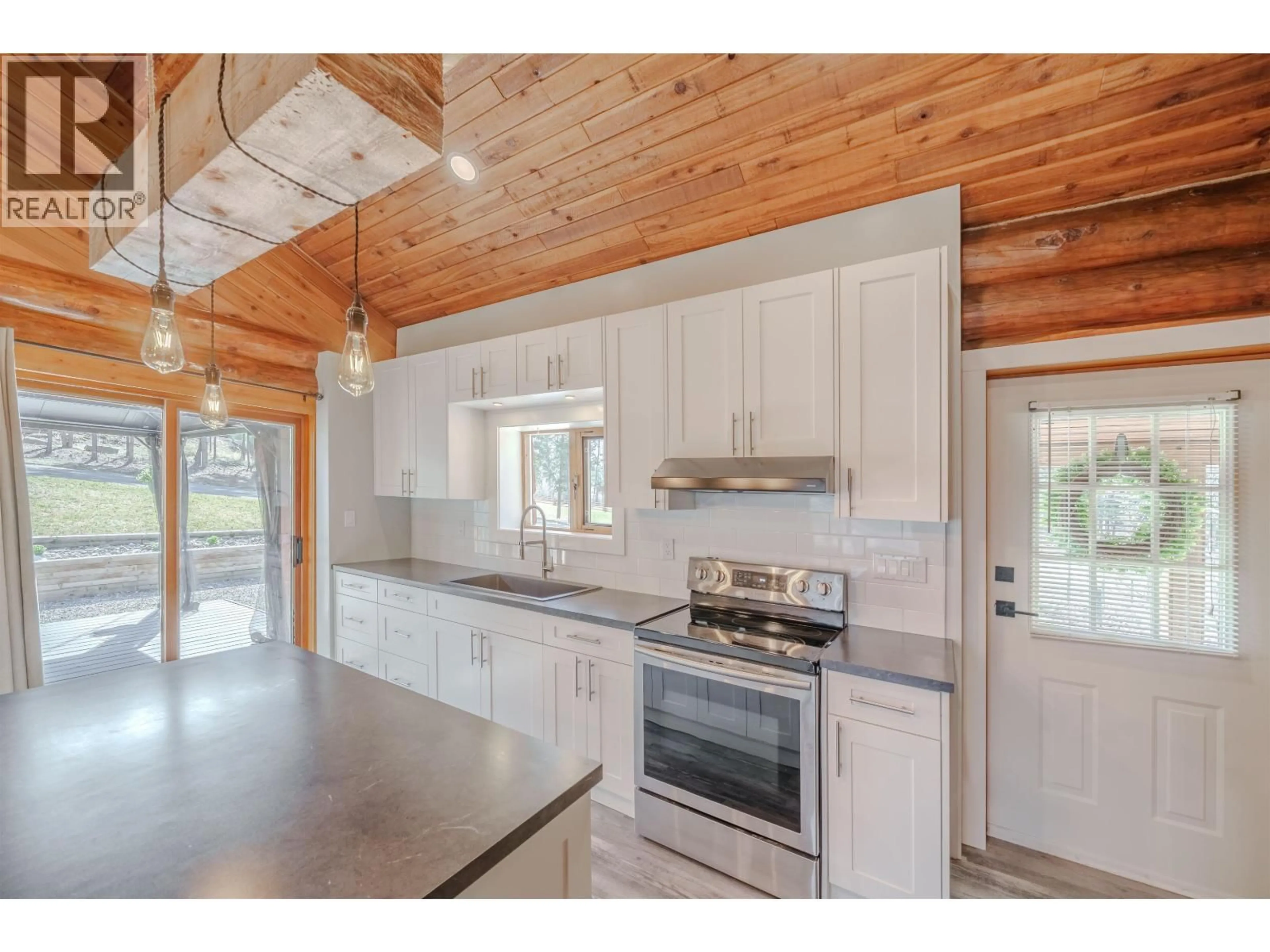 Open concept kitchen, wood/laminate floor for 5231 DAVIS ROAD, 108 Mile Ranch British Columbia V0K2Z0