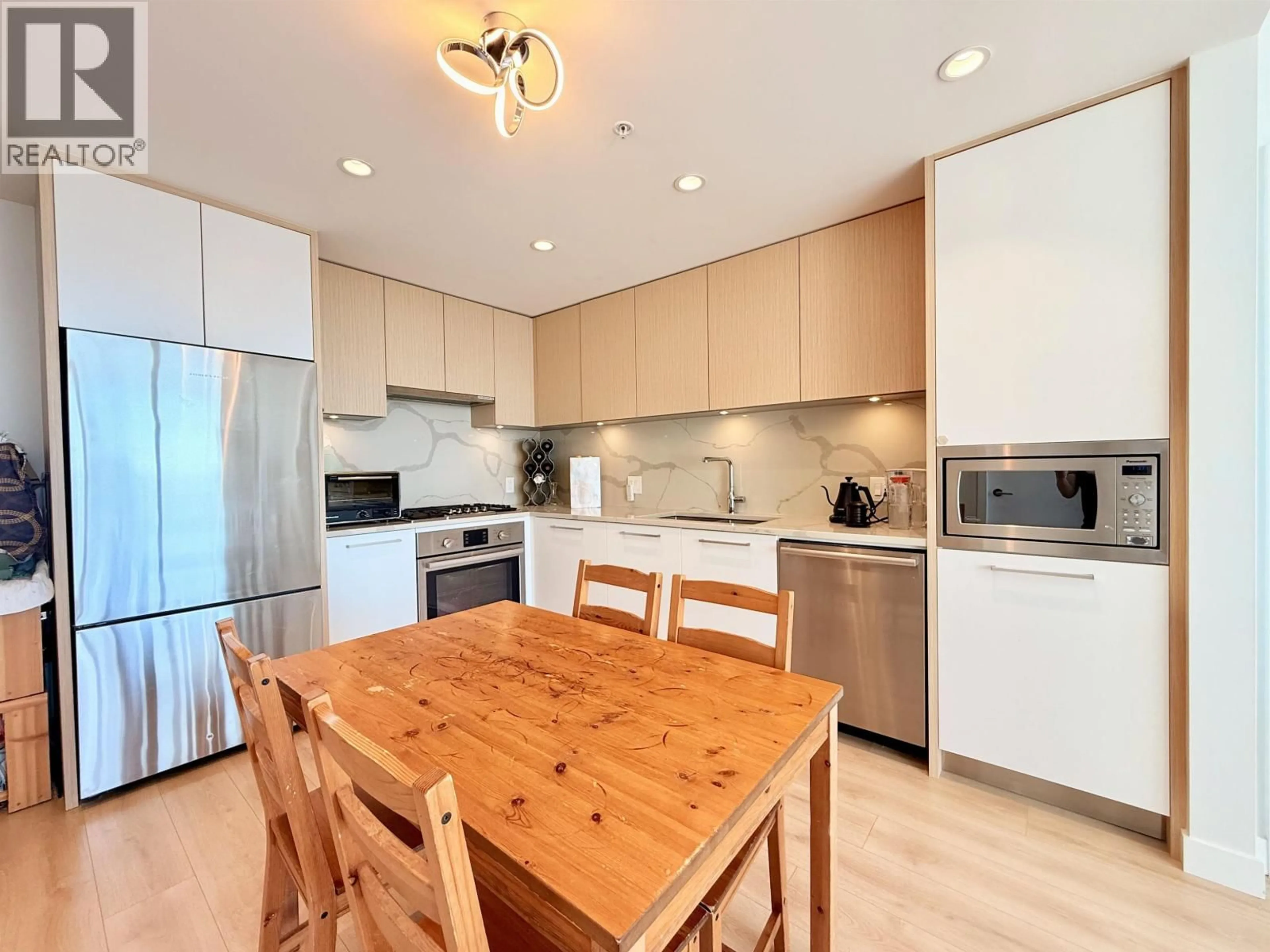 Open concept kitchen, wood/laminate floor for 2101 - 567 CLARKE ROAD, Coquitlam British Columbia V3J0K7