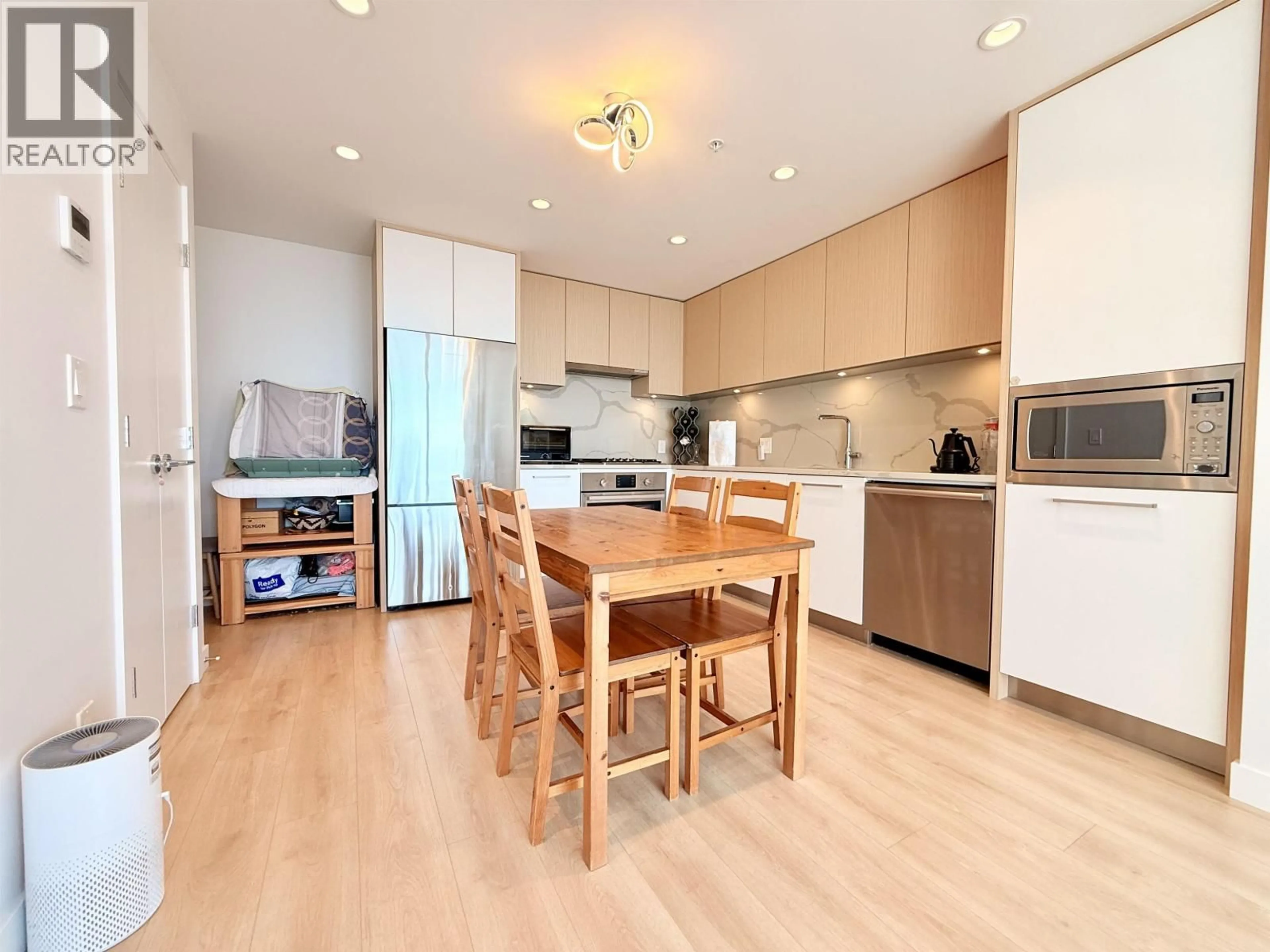 Open concept kitchen, wood/laminate floor for 2101 - 567 CLARKE ROAD, Coquitlam British Columbia V3J0K7