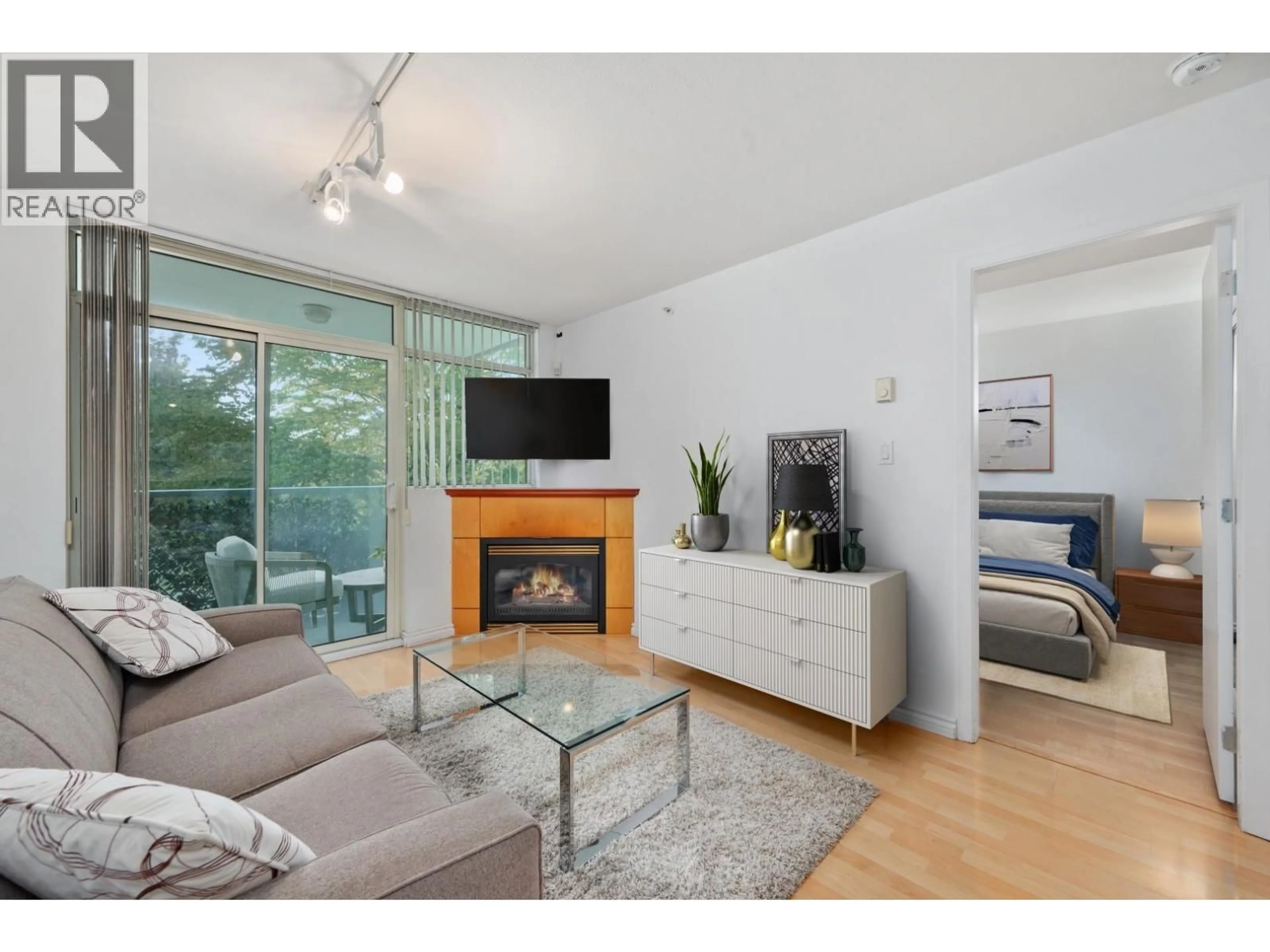 Living room with furniture, wood/laminate floor for 205 - 2733 CHANDLERY PLACE, Vancouver British Columbia V5S4V3