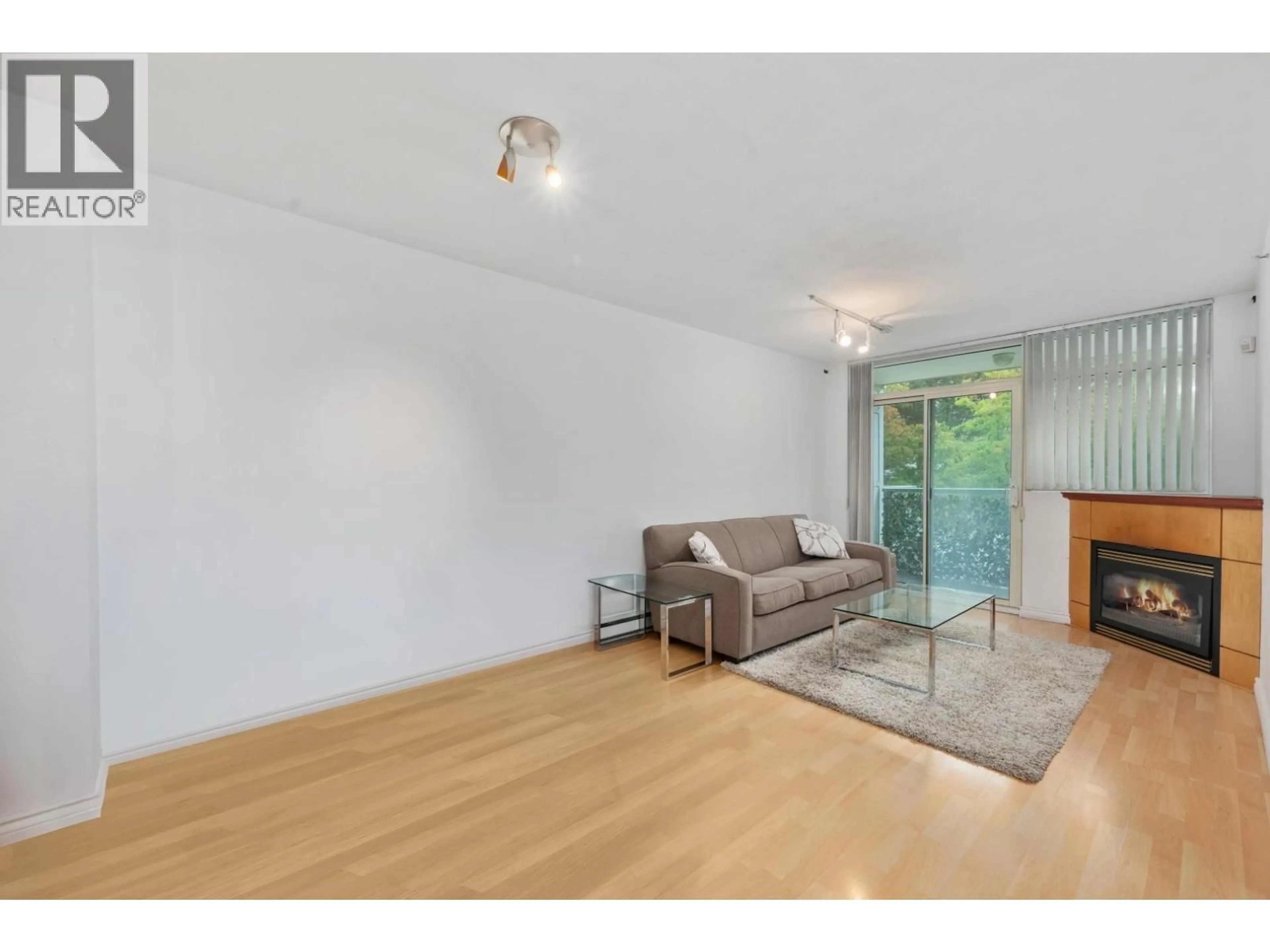 Living room with furniture, wood/laminate floor for 205 - 2733 CHANDLERY PLACE, Vancouver British Columbia V5S4V3