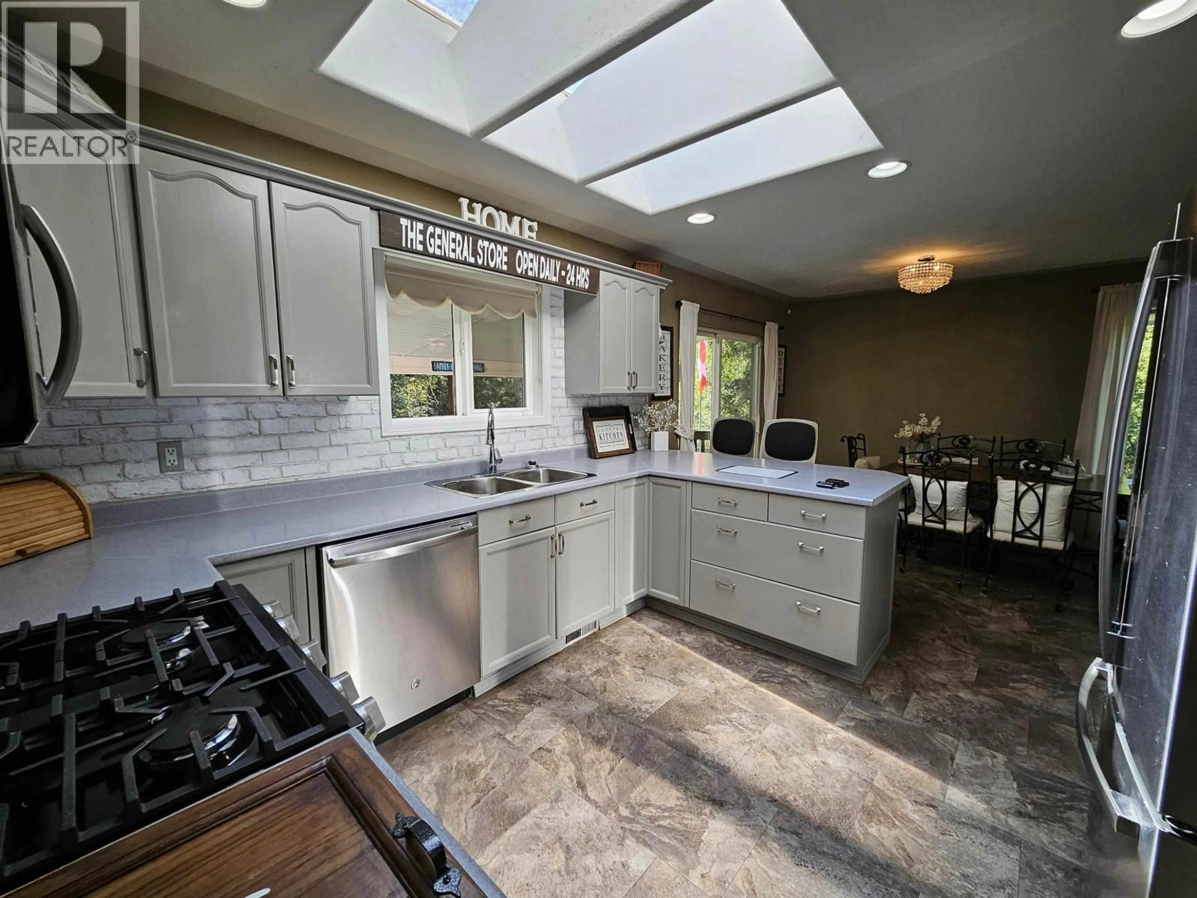 Contemporary kitchen, ceramic/tile floor for 4887 MEESQUONO TRAIL, 108 Mile Ranch British Columbia V0K2Z0
