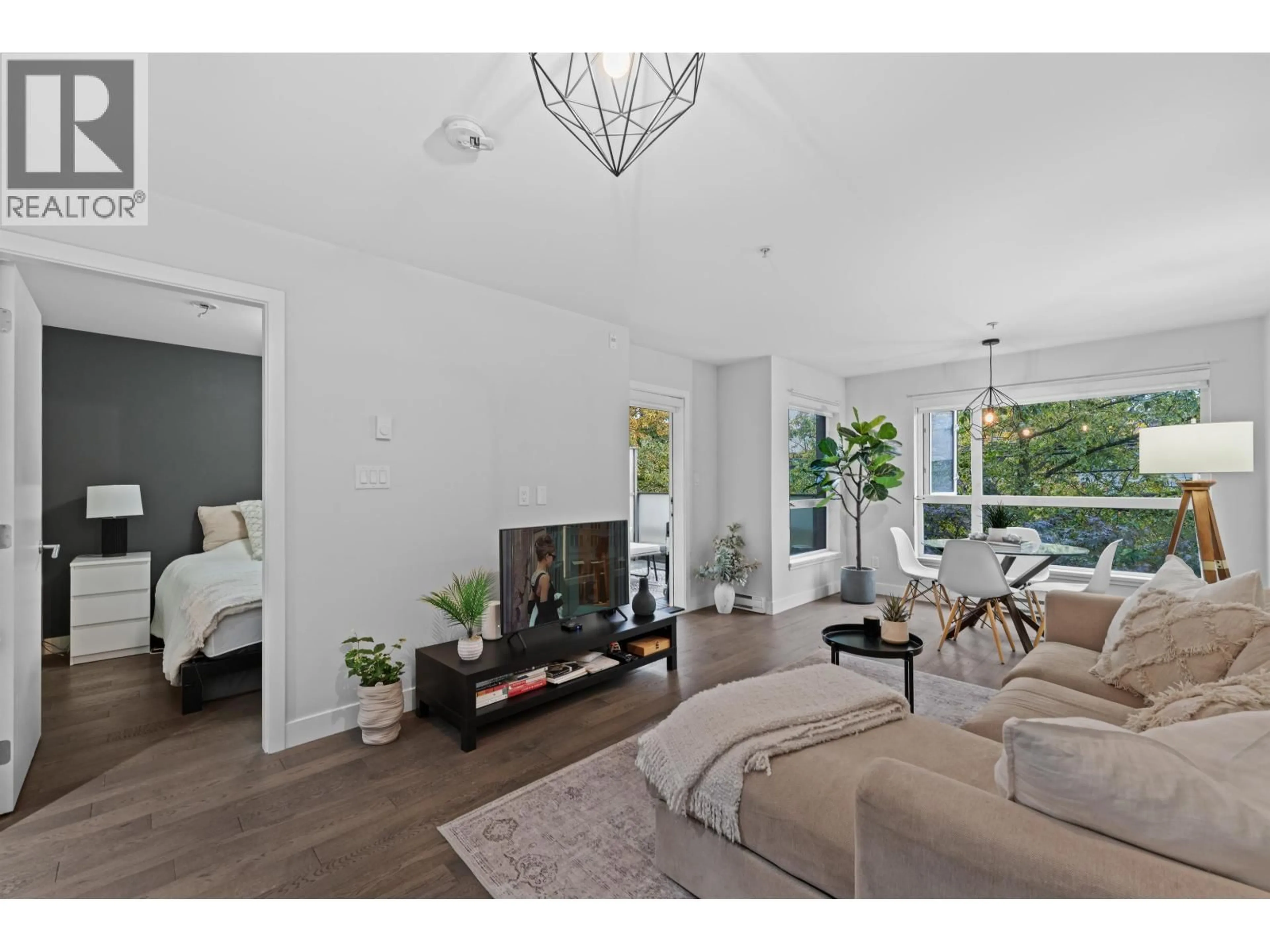 Living room with furniture, wood/laminate floor for 208 - 3456 COMMERCIAL STREET, Vancouver British Columbia V5N4E9