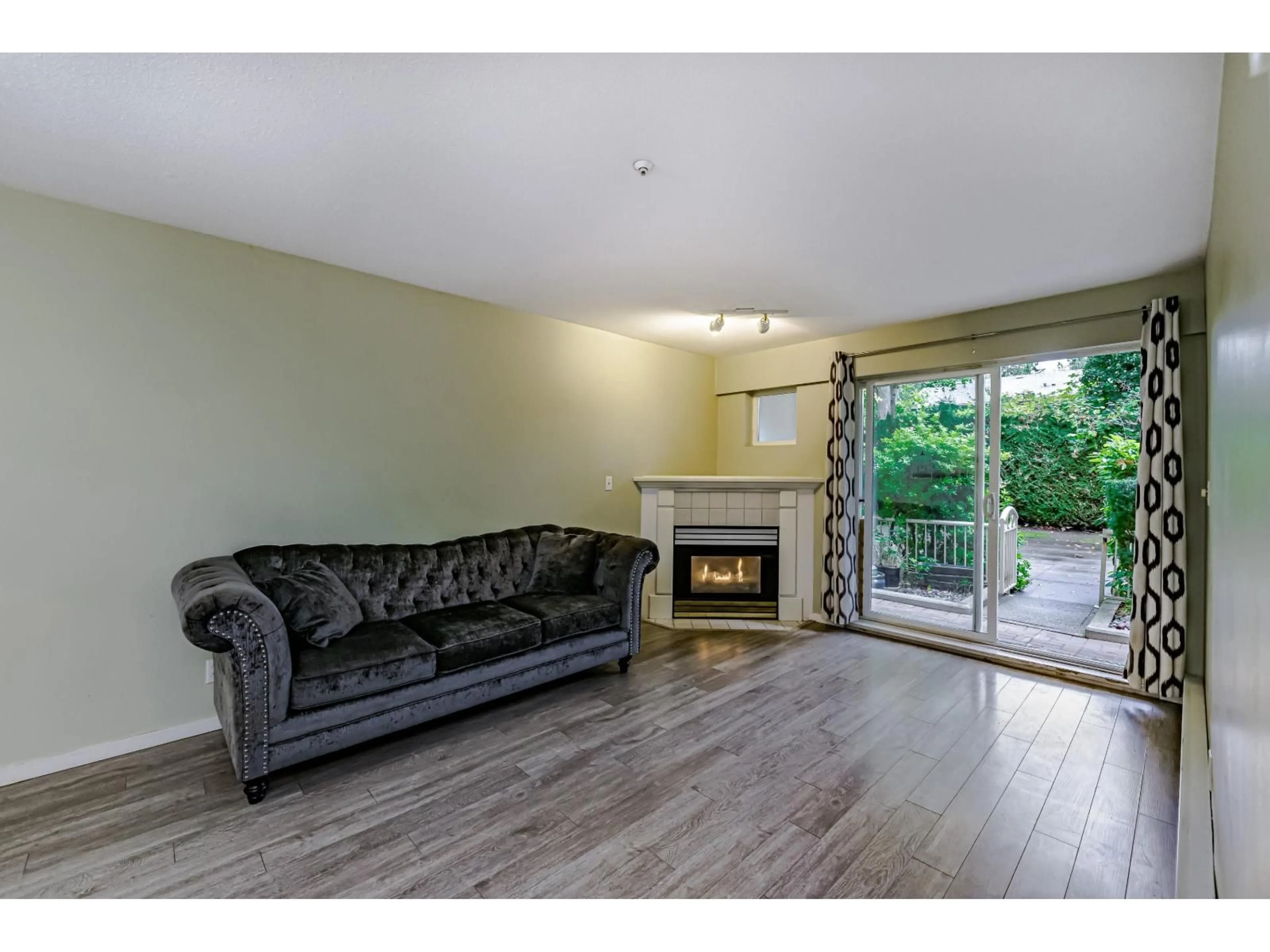 Living room with furniture, wood/laminate floor for D102 - 9838 WHALLEY, Surrey British Columbia V3T5S8